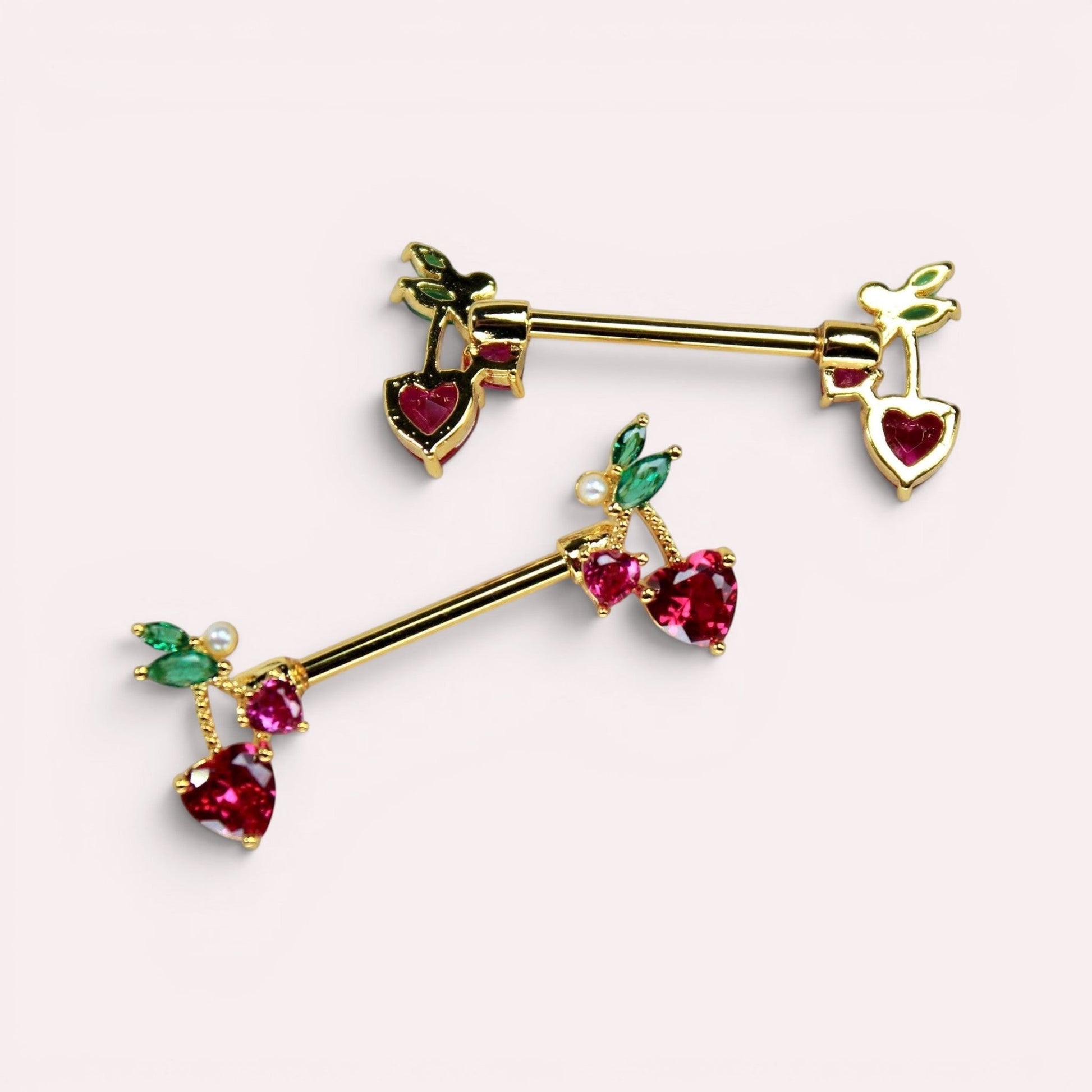 MKBodyJewelry gold cherry heart nipple barbell set in surgical steel with red and green gemstone accents.