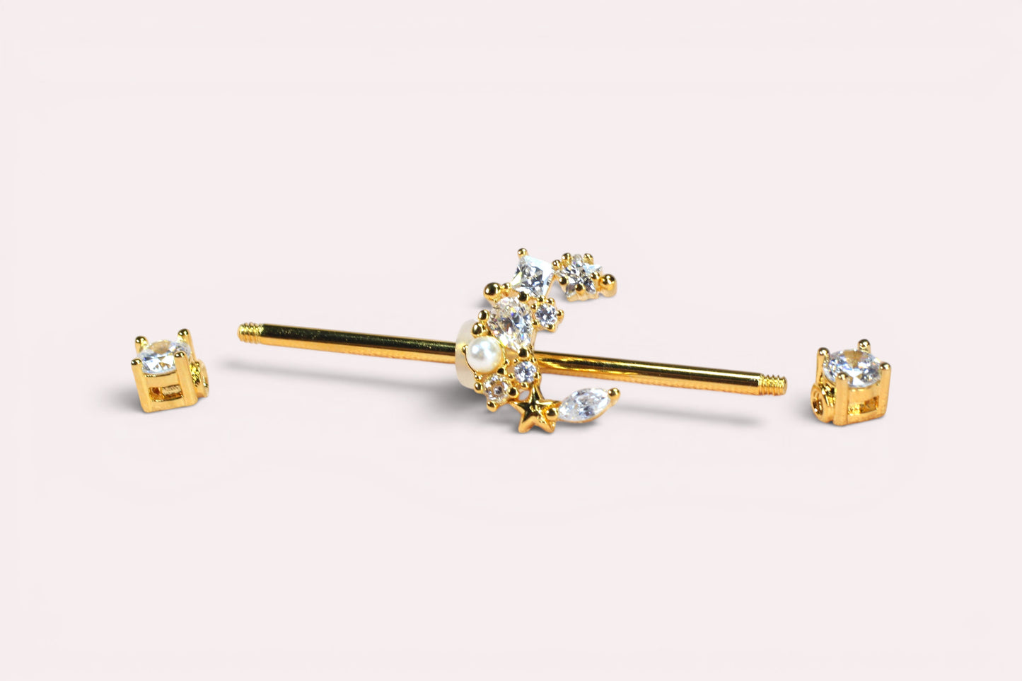 MKBodyJewelry gold industrial barbell with a crescent moon charm adorned with crystals and a pearl. Surgical steel.