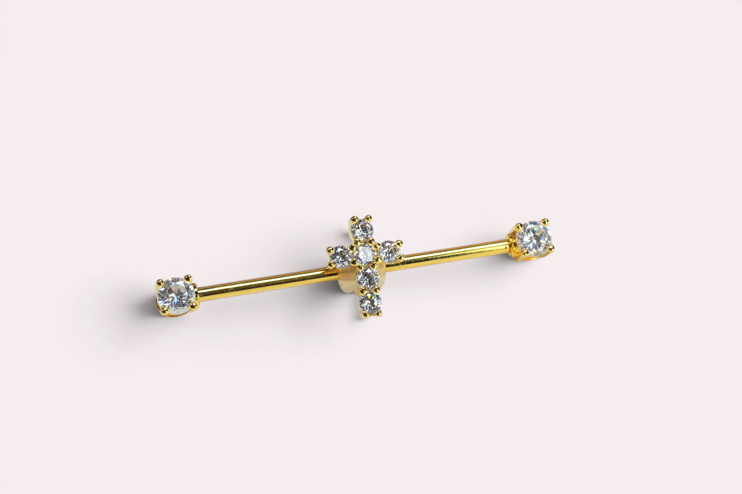 MKBodyJewelry gold industrial barbell with a dainty cross charm adorned with clear crystals. Surgical steel, 14G, 35mm.
