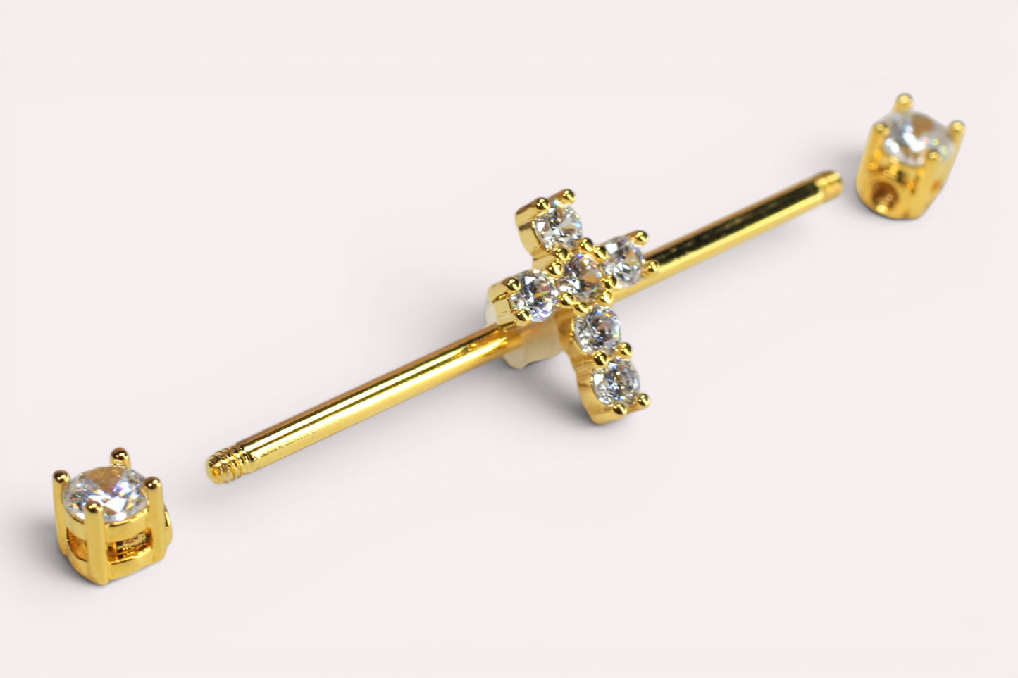 MKBodyJewelry gold 14G surgical steel industrial barbell with a sparkling Jesus cross charm and clear cubic zirconia ends.