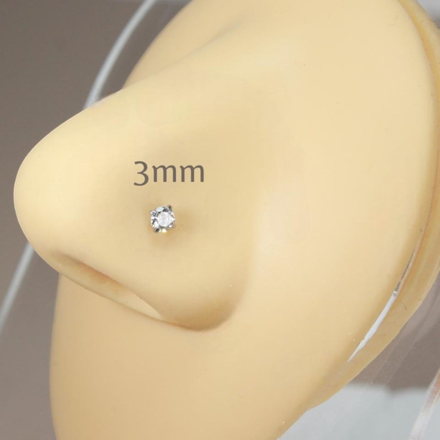 MKBodyJewelry 3mm round cut cubic zirconia nose stud in a gold-tone four-prong setting on a mannequin nose