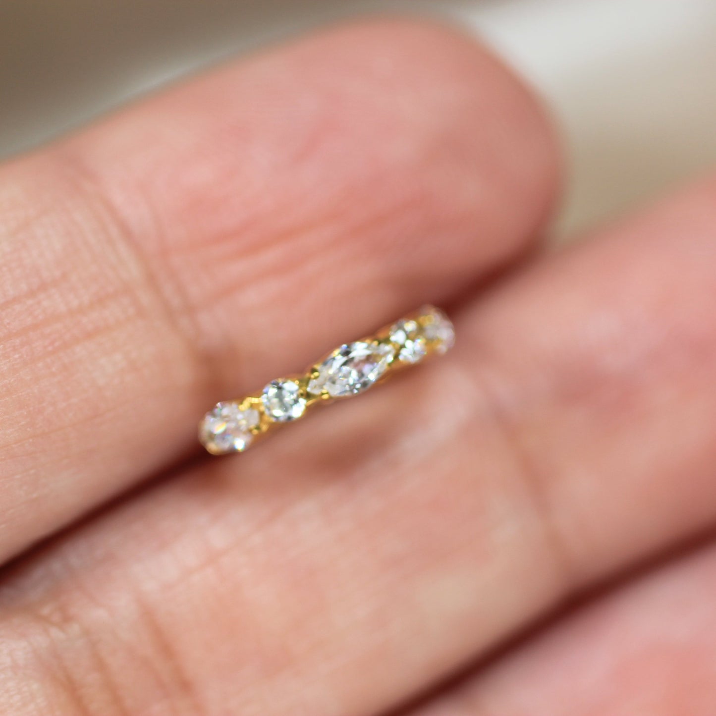 MKBodyJewelry gold titanium nose clicker ring featuring dainty marquise and round CZ gems for a secure snug fit.