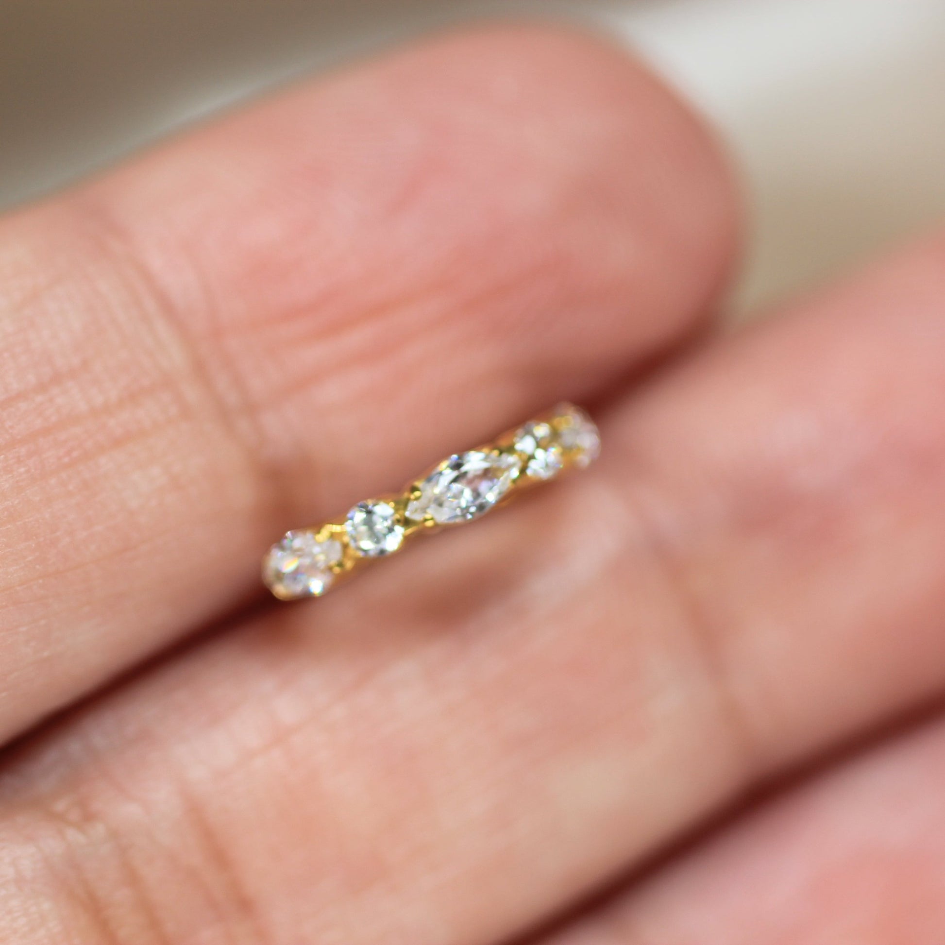 MKBodyJewelry gold titanium nose clicker ring featuring dainty marquise and round CZ gems for a secure snug fit.