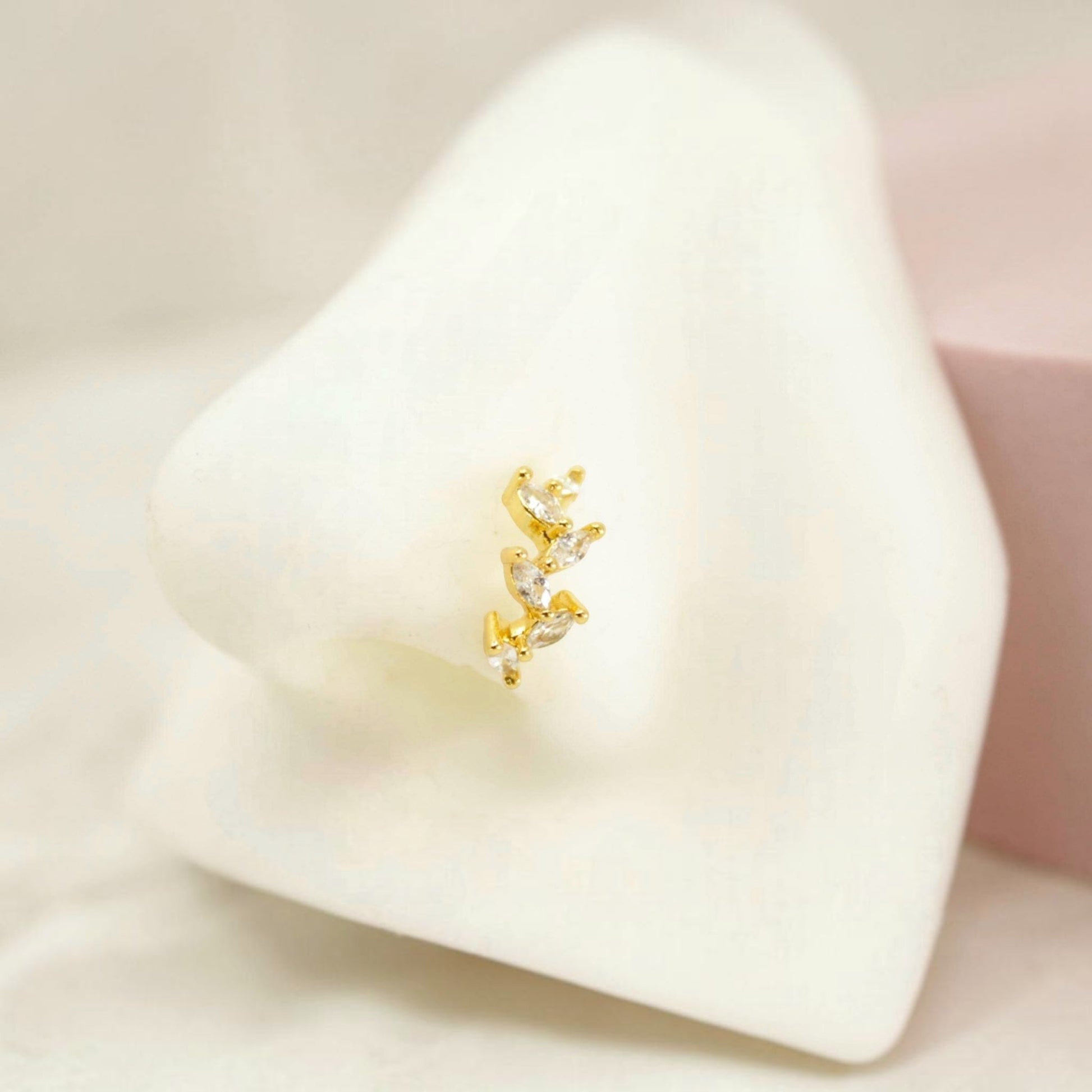 MKBodyJewelry dainty gold bendable nose hoop ring with sparkling CZ stones on a white nose mannequin display