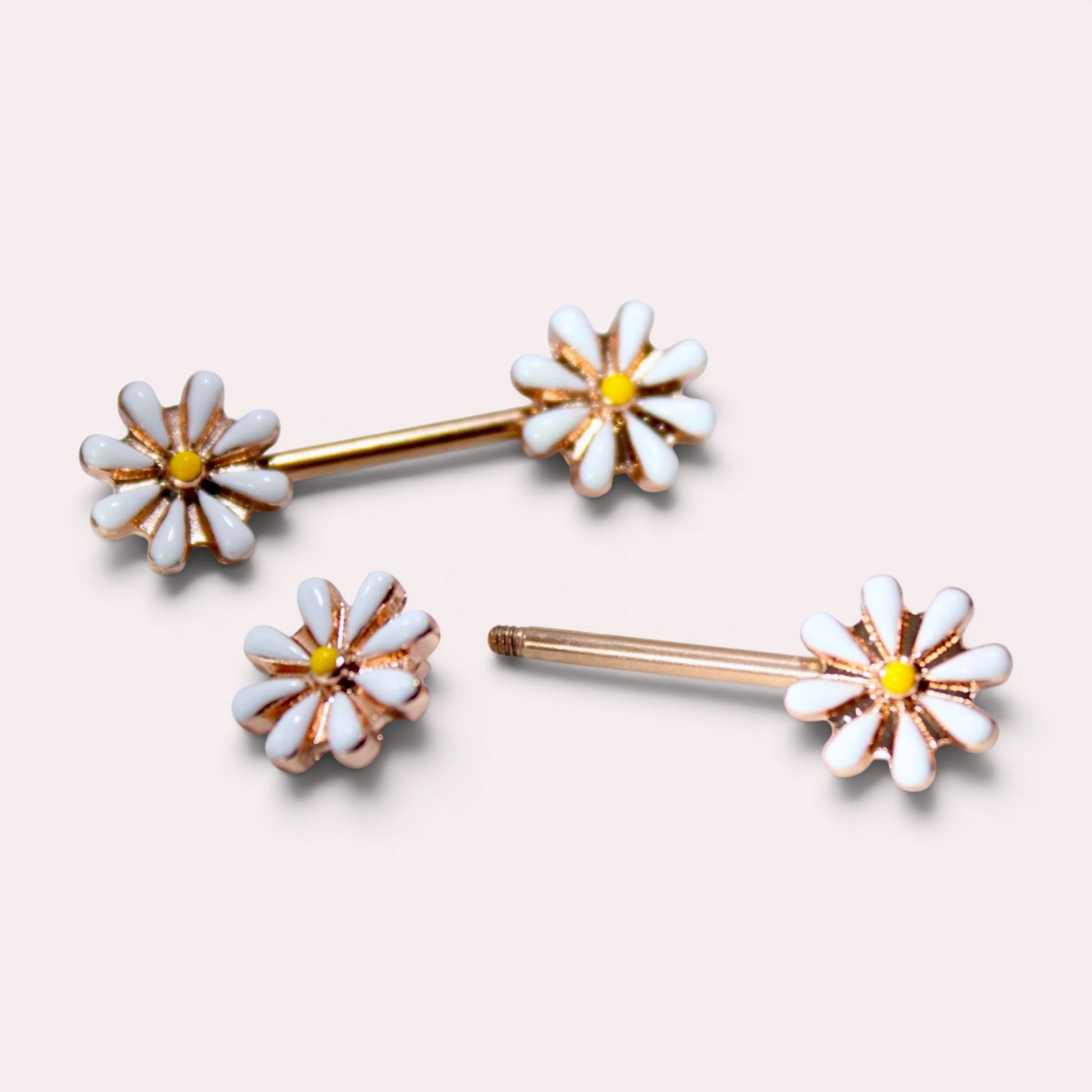 MKBodyJewelry 14G gold surgical steel nipple barbells featuring white and yellow daisy flower designs, sold as a pair.