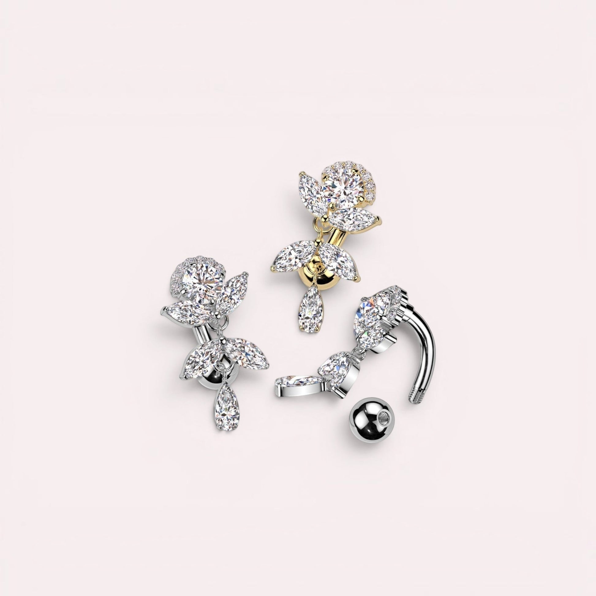 MKBodyJewelry gold inverted floral titanium belly button ring with CZ stones and a dangling pear-shaped charm.