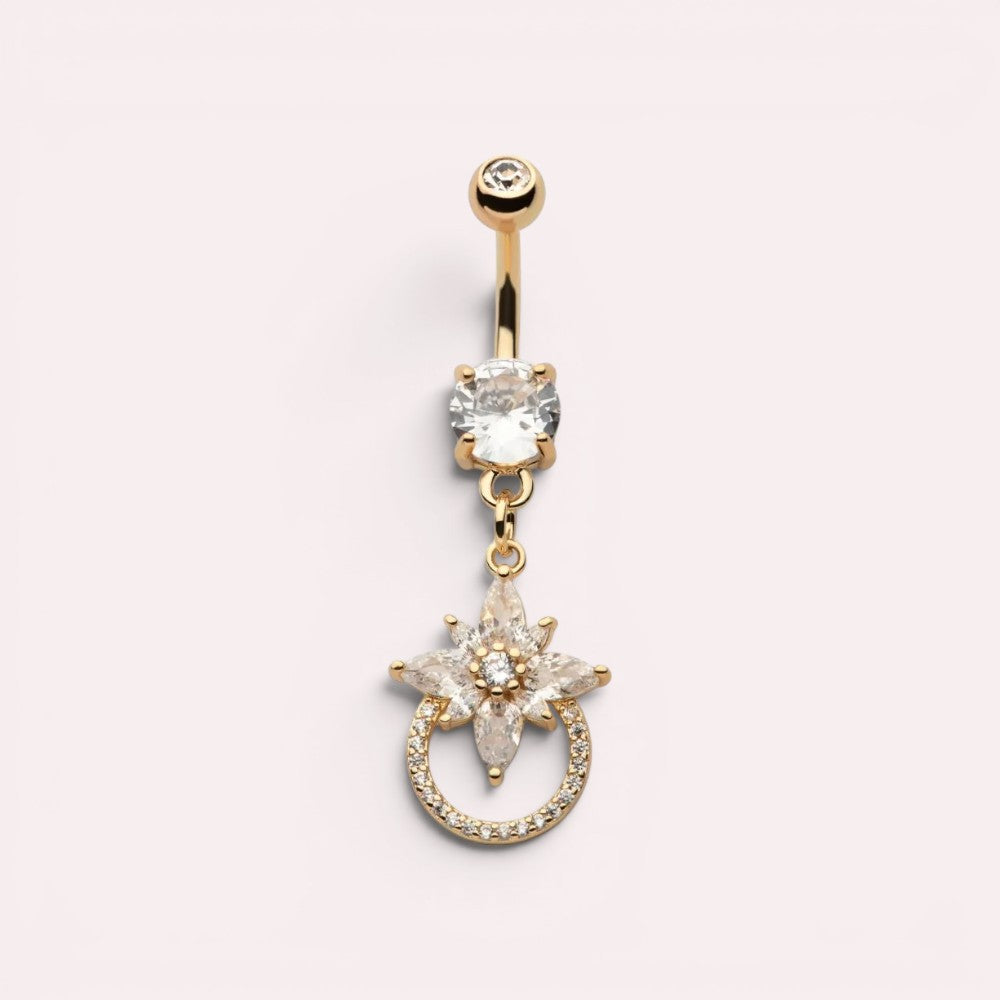 MKBodyJewelry 14g gold surgical steel belly button ring with a dangling floral charm and sparkling CZ stones.
