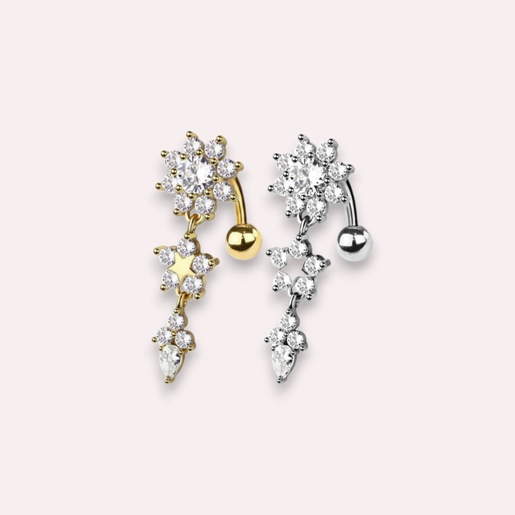 MKBodyJewelry gold-tone dangling belly button ring featuring a floral motif, star charm, and cubic zirconia crystals.