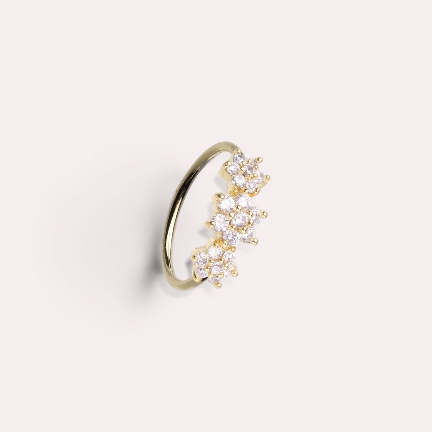 MKBodyJewelry gold surgical steel nose hoop with three sparkling floral CZ gems, suitable for nose or cartilage.