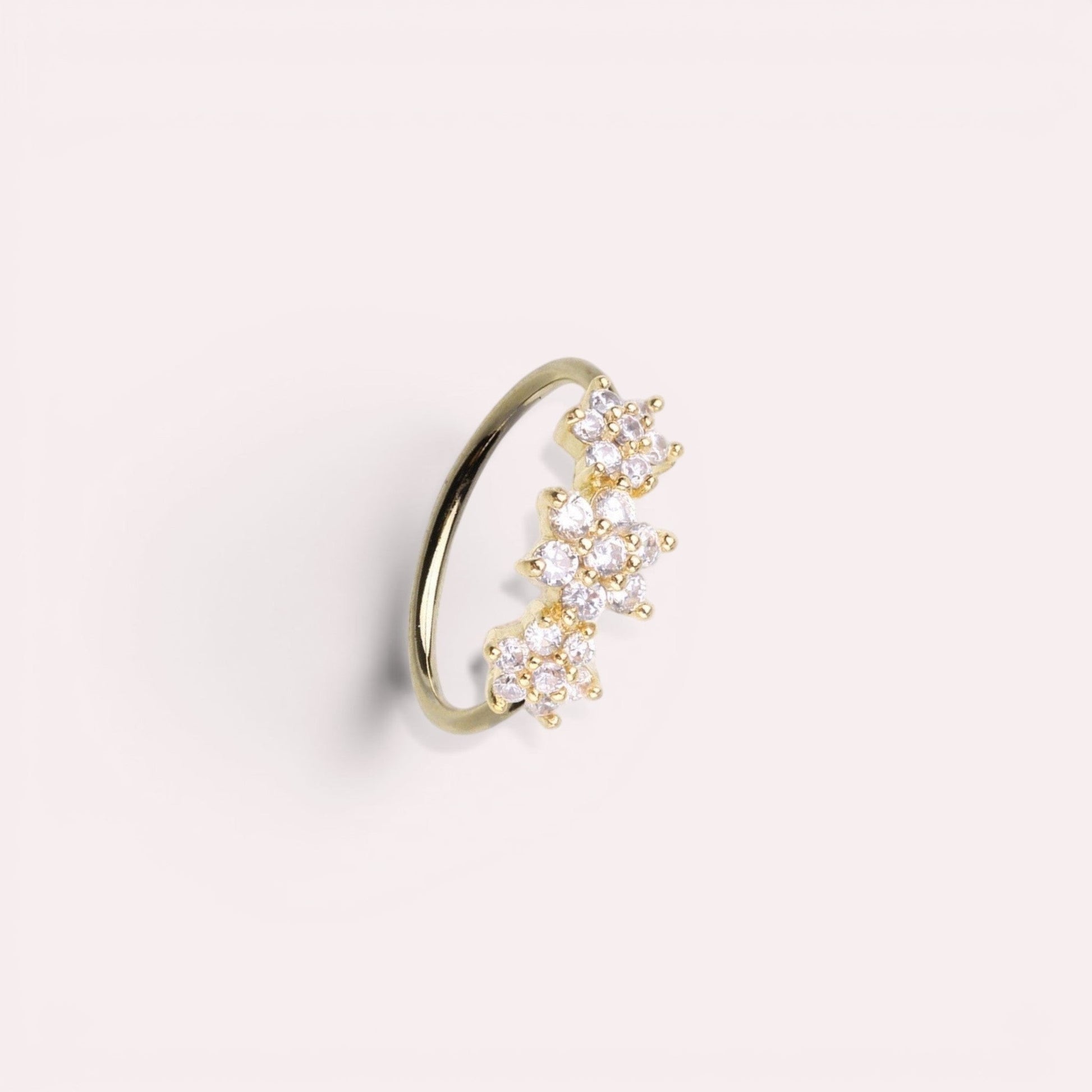 MKBodyJewelry gold surgical steel nose hoop with three sparkling floral CZ gems, suitable for nose or cartilage.