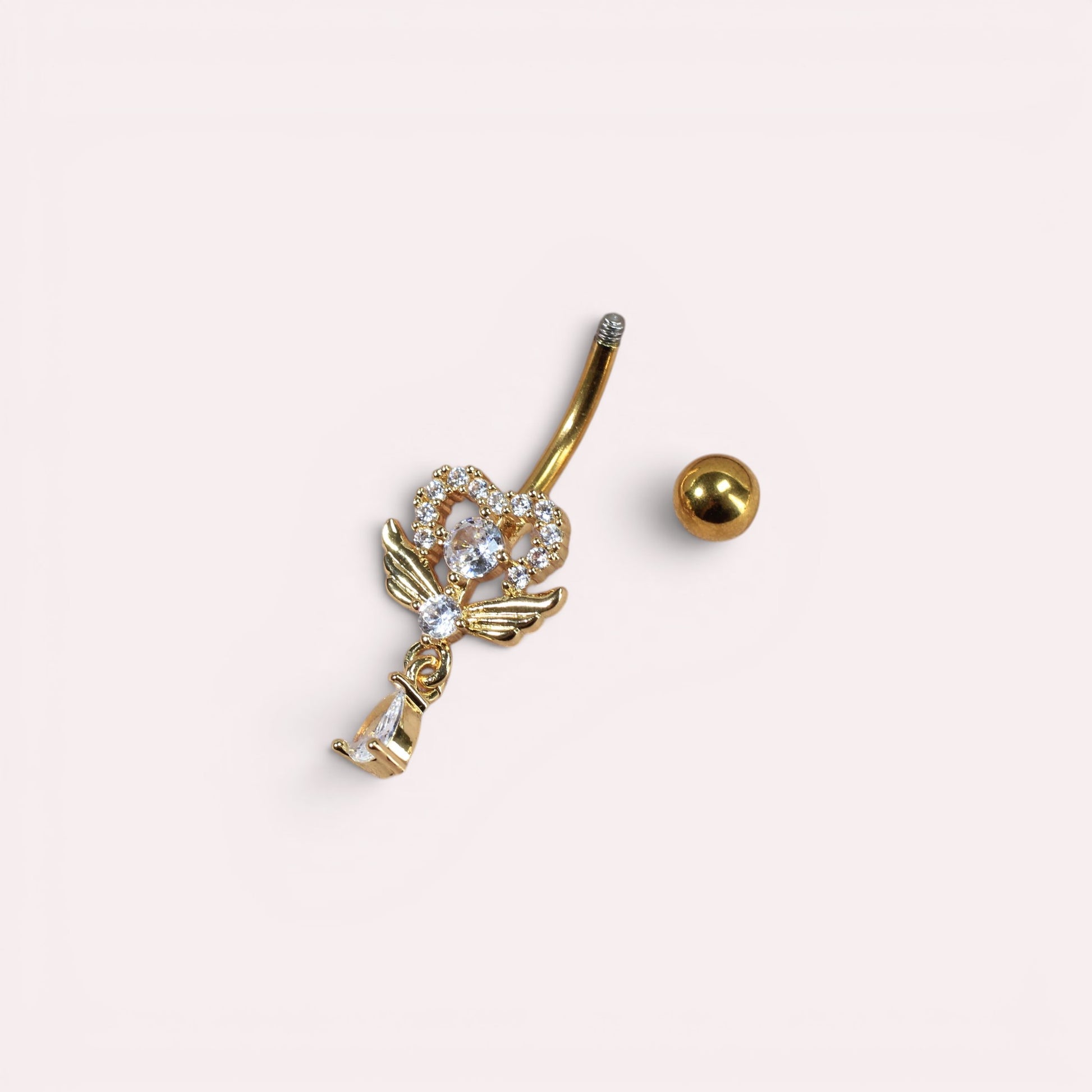 MKBodyJewelry 14G gold stainless steel belly button ring with a winged heart charm and sparkling cubic zirconia
