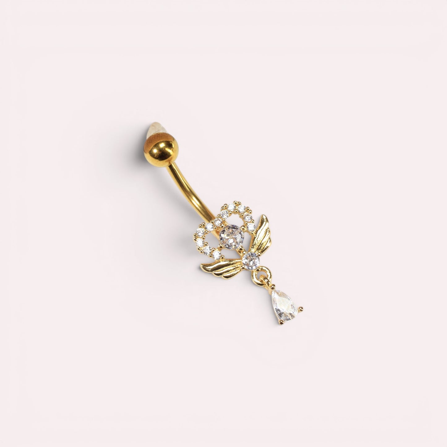 MKBodyJewelry gold heart belly button ring with angel wings, cubic zirconia crystals, and a dangling teardrop charm.