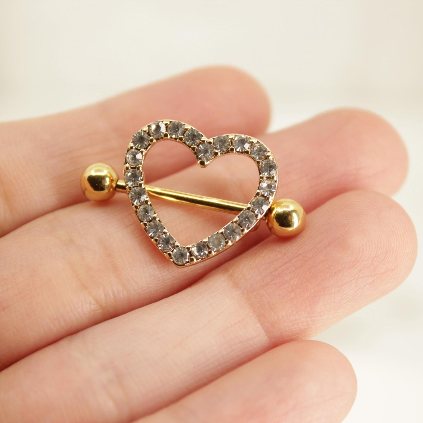 MKBodyJewelry gold heart nipple barbell with sparkling paved gemstones on a surgical steel 14g piercing ring