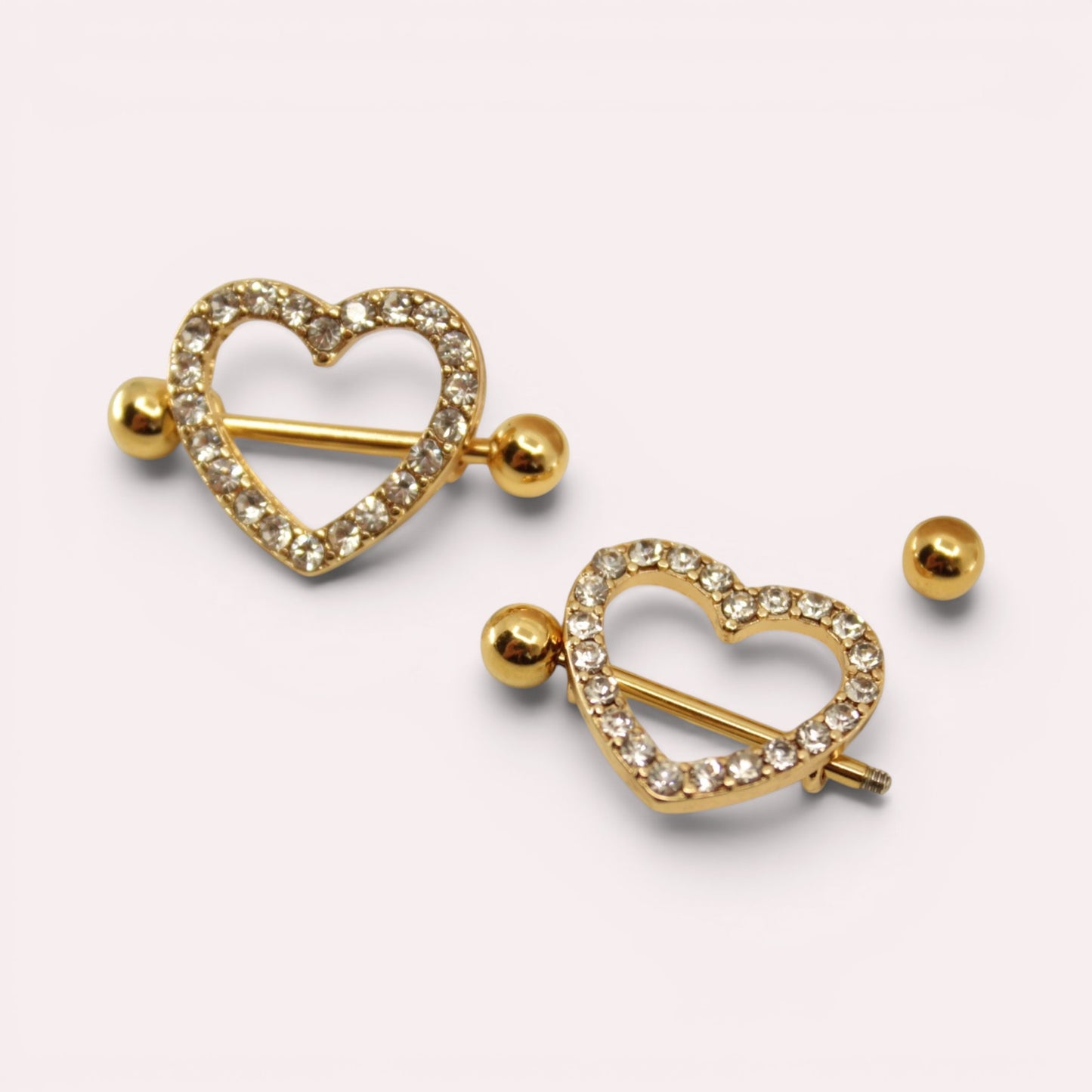 MKBodyJewelry gold heart nipple barbells with sparkling pave gemstones, crafted from surgical steel.