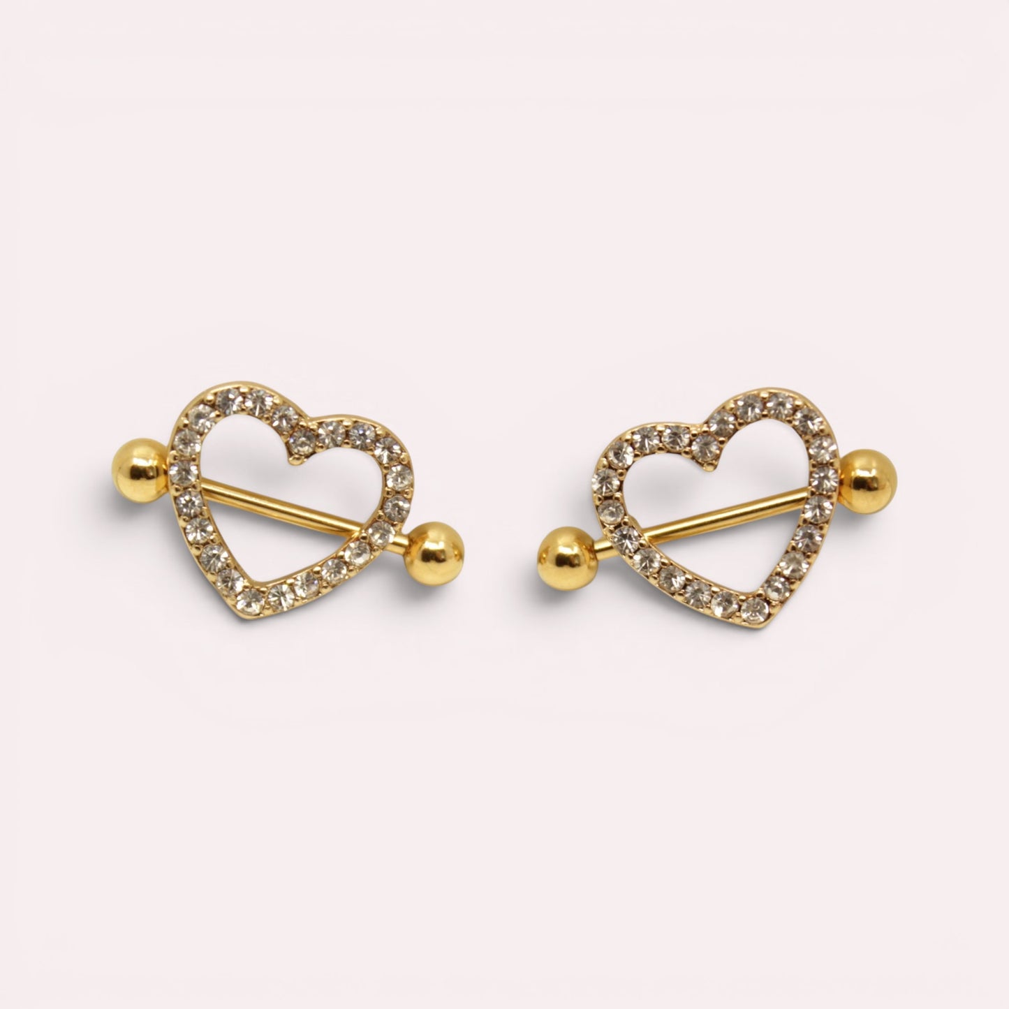 MKBodyJewelry gold heart nipple barbells with sparkling pave gemstones, crafted from surgical steel.