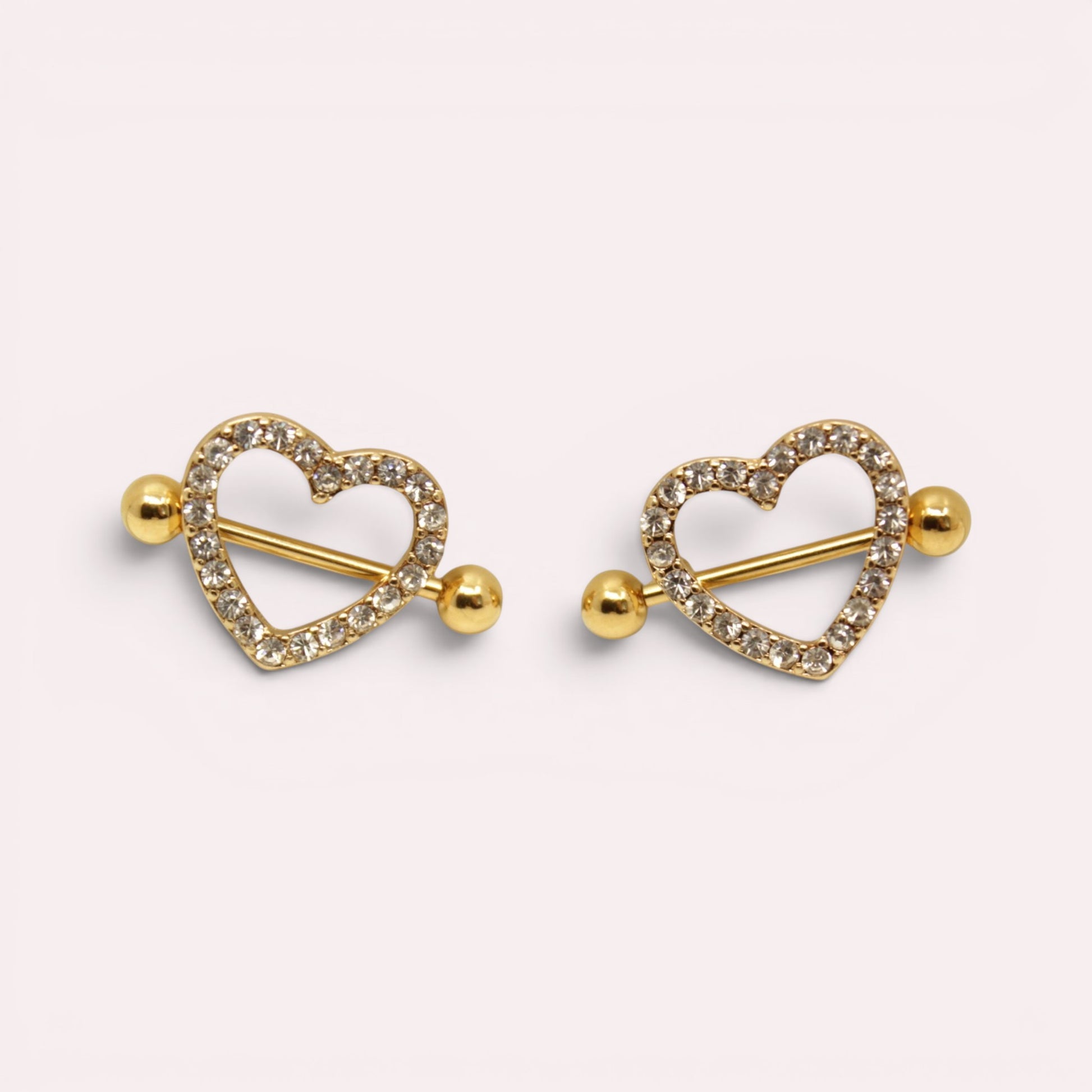 MKBodyJewelry gold heart nipple barbells with sparkling pave gemstones, crafted from surgical steel.