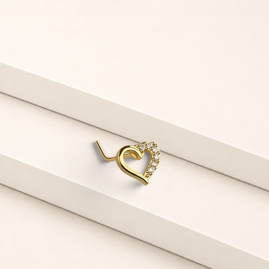 MKBodyJewelry 20G gold heart nose stud with sparkling CZ gems in an L-shape design for comfortable piercing wear.