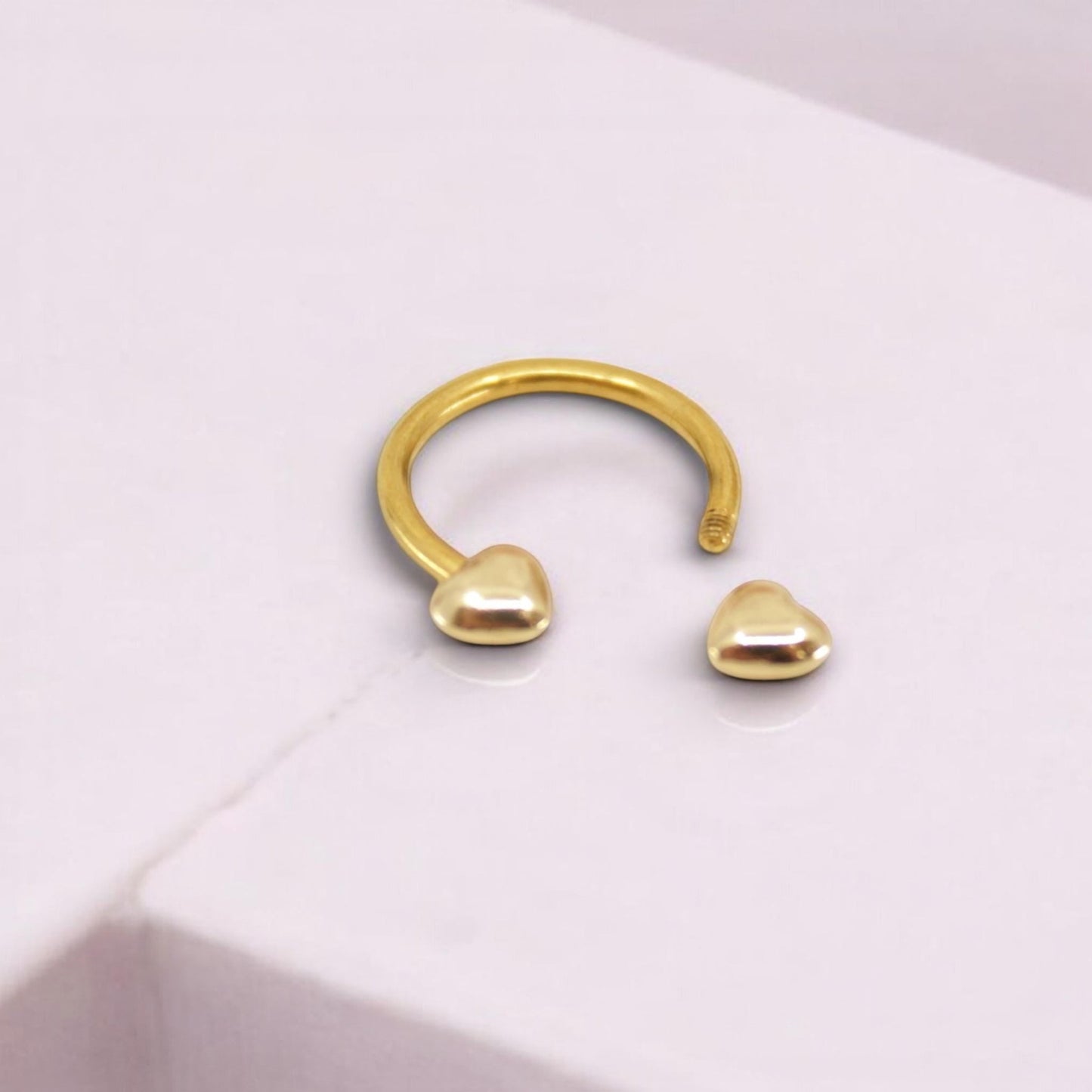 MKBodyJewelry gold heart horseshoe septum ring made of surgical steel for minimalist nose piercing jewelry.