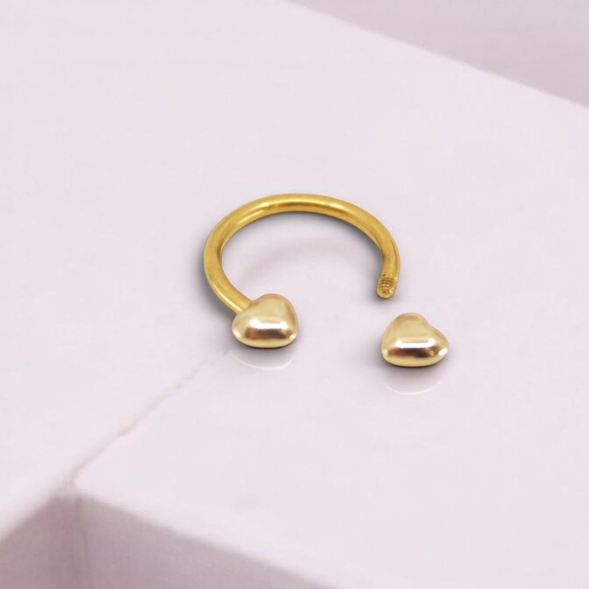 MKBodyJewelry gold heart horseshoe septum ring made of surgical steel for minimalist nose piercing jewelry.