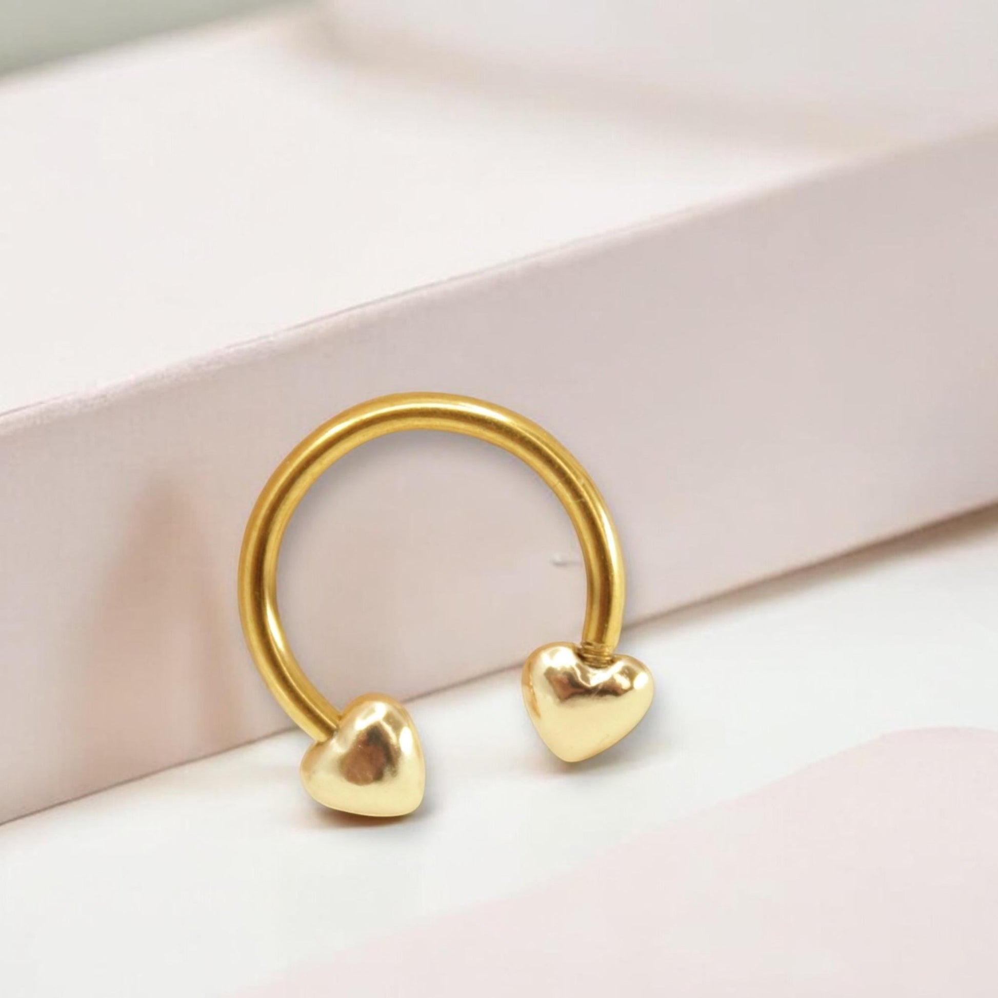 MKBodyJewelry 16G gold surgical steel horseshoe septum ring with heart-shaped ends for minimalist nose piercing