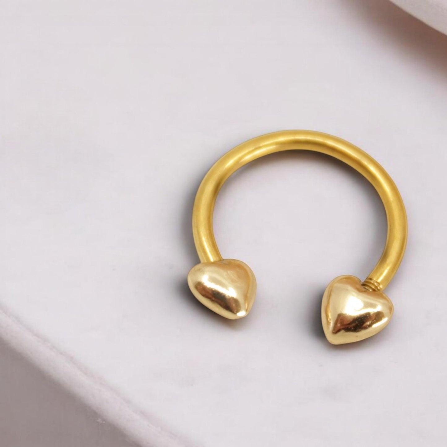 MKBodyJewelry gold heart horseshoe septum ring made of surgical steel, minimalist nose piercing jewelry.