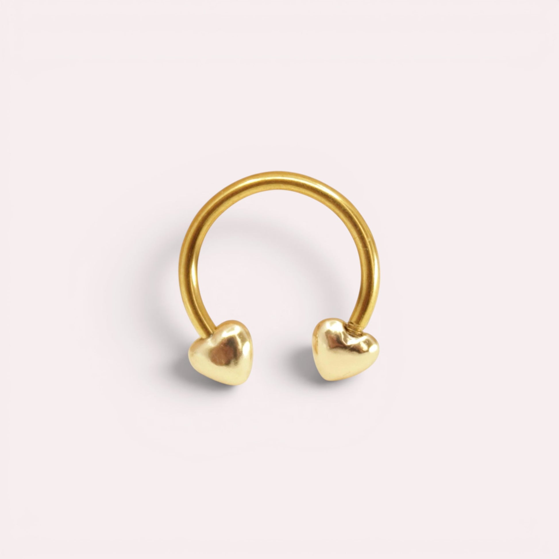 MKBodyJewelry 16G gold surgical steel horseshoe septum ring featuring minimalist heart-shaped ends.