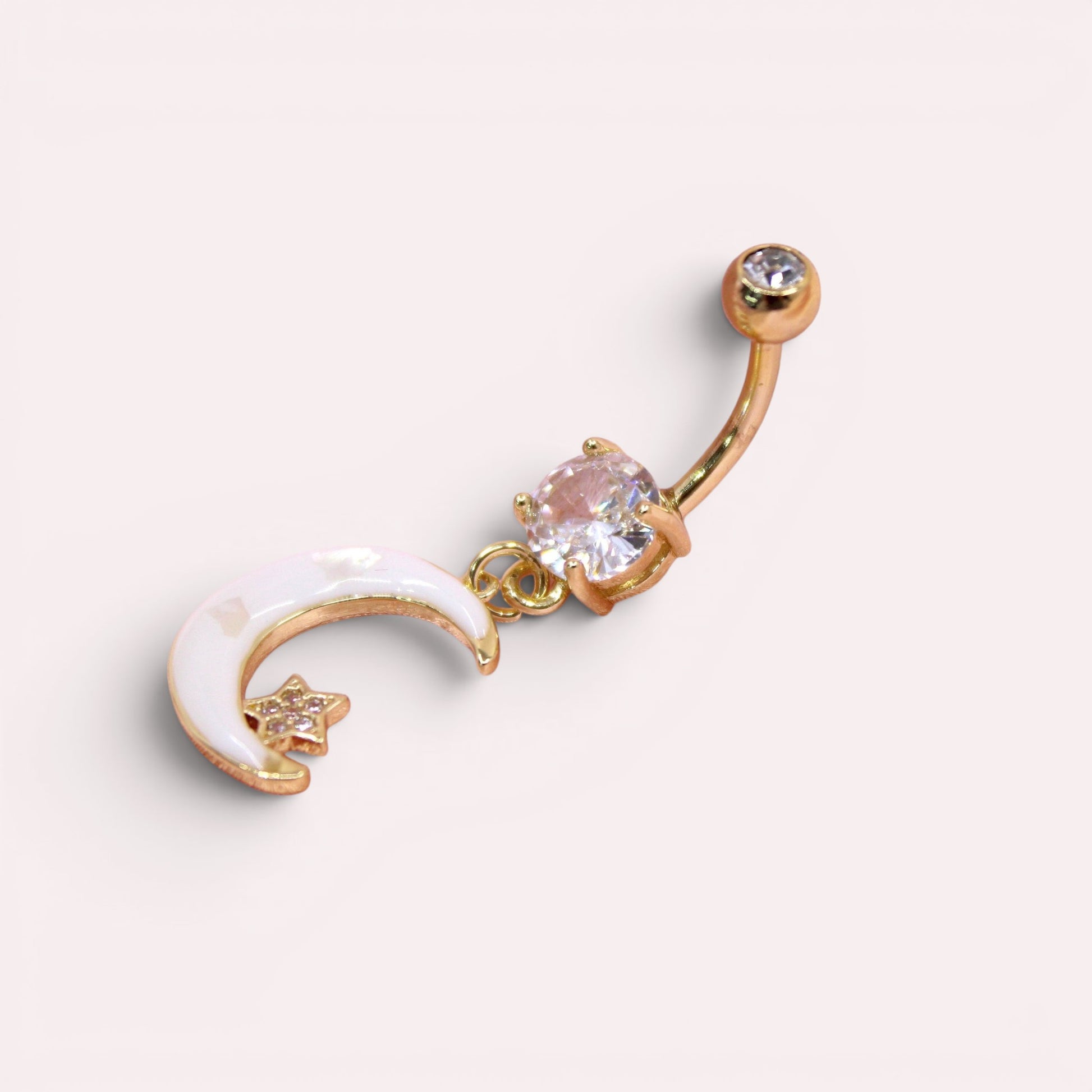 MKBodyJewelry gold-tone stainless steel belly button ring with a white crescent moon, star, and clear crystal charm.