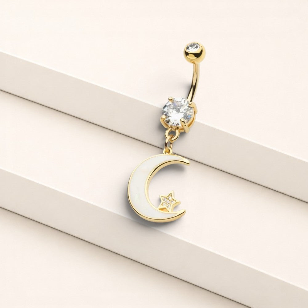 MKBodyJewelry gold stainless steel belly button ring with a dangling moon charm, white inlay, and clear crystal.