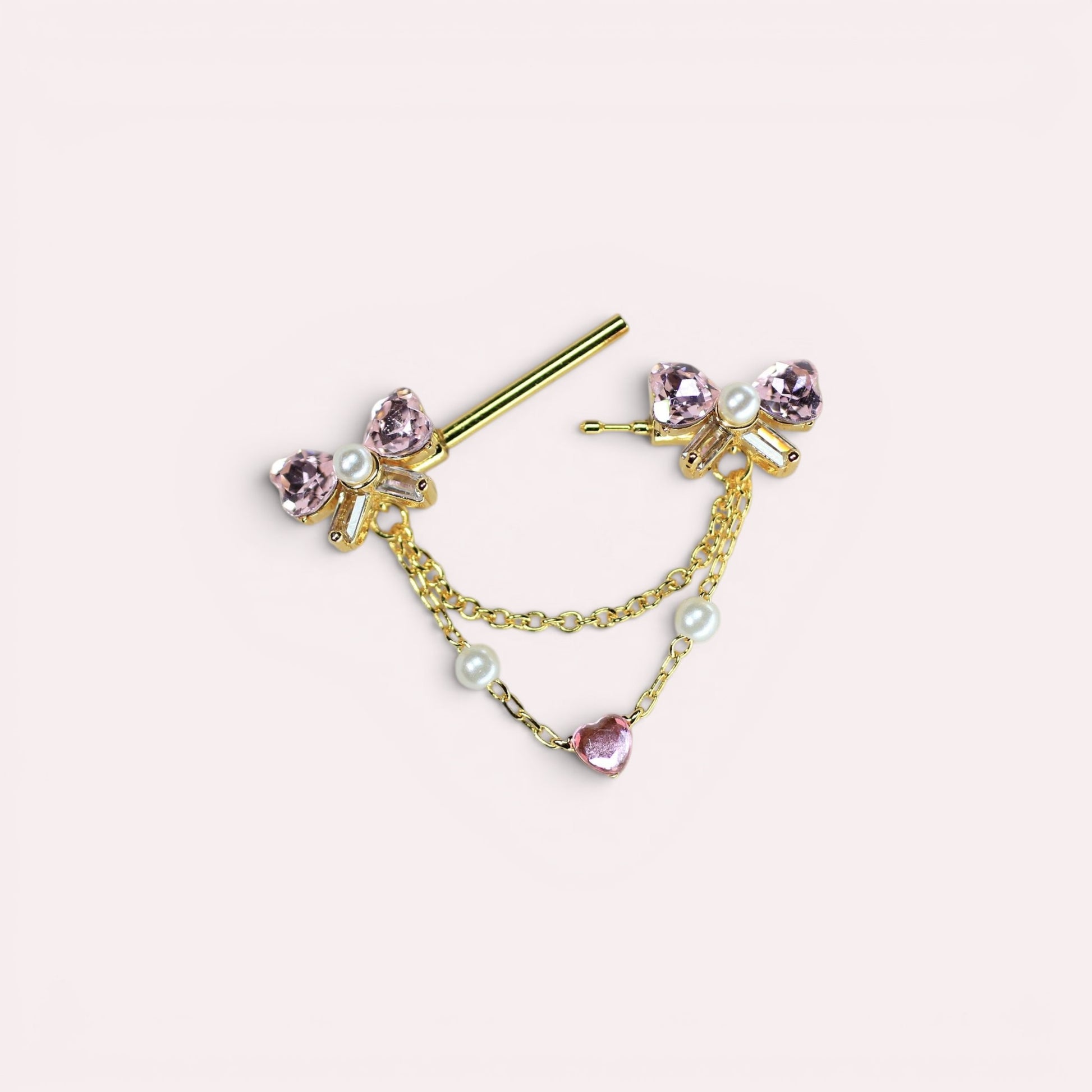 MKBodyJewelry gold 14g nipple barbell with pink bow heart charms, pearls, and chains. Surgical steel.