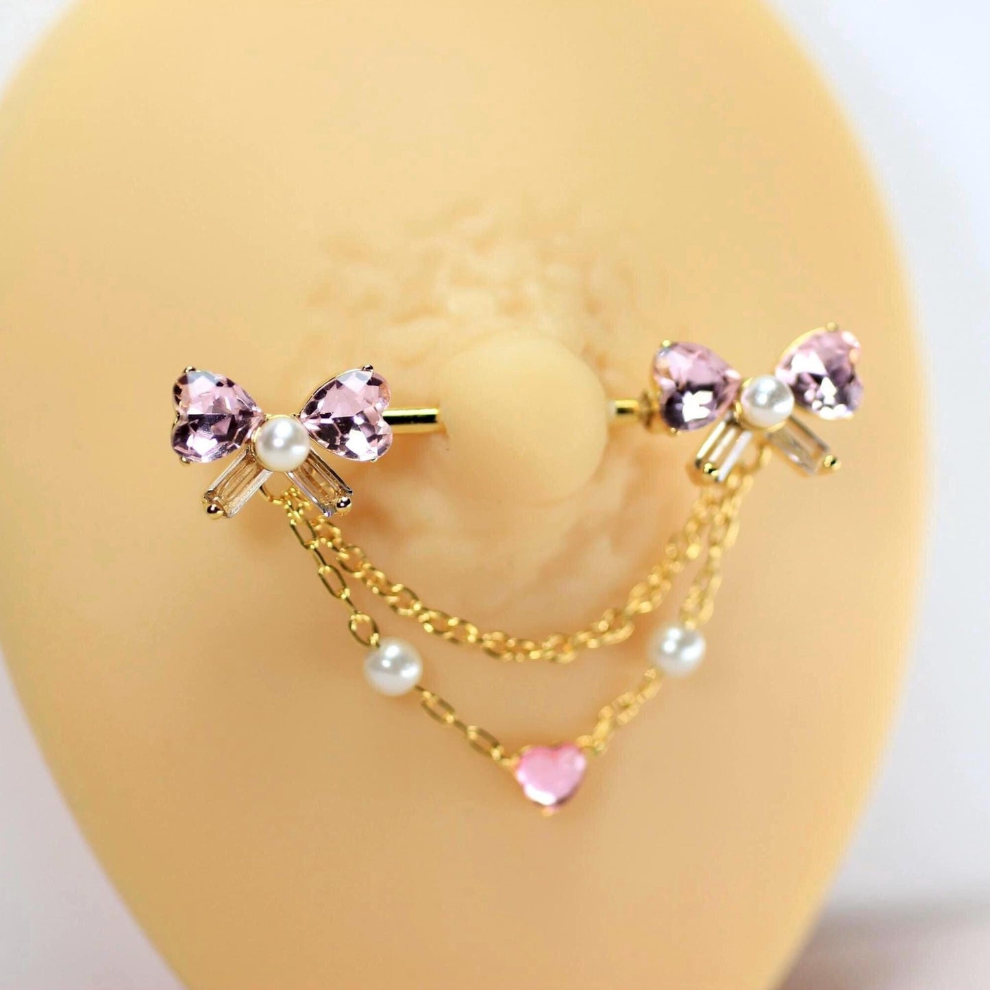 MKBodyJewelry 14g gold barbell with pink bow heart dangle chain, surgical steel, pearl accents.