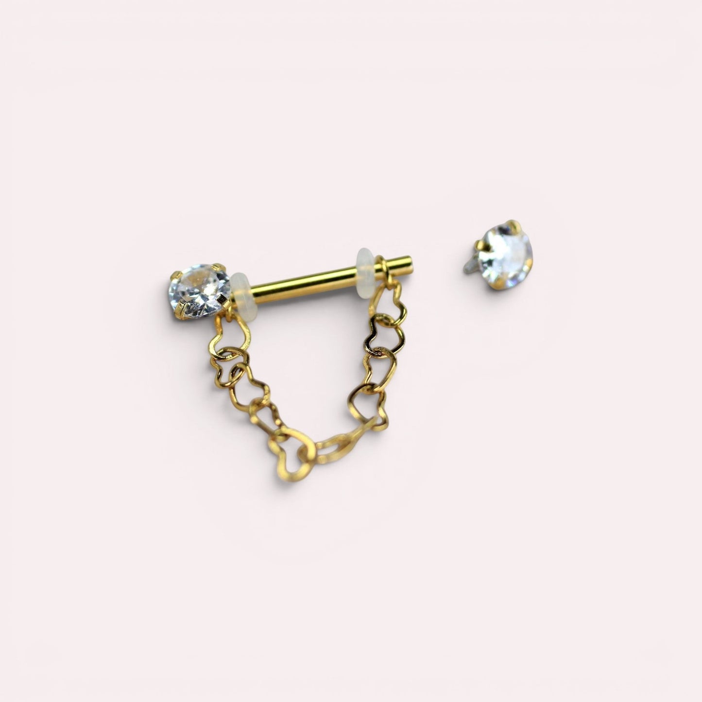 MKBodyJewelry gold surgical steel nipple barbell with dangling heart chain and CZ prong end. Sold as a pair.
