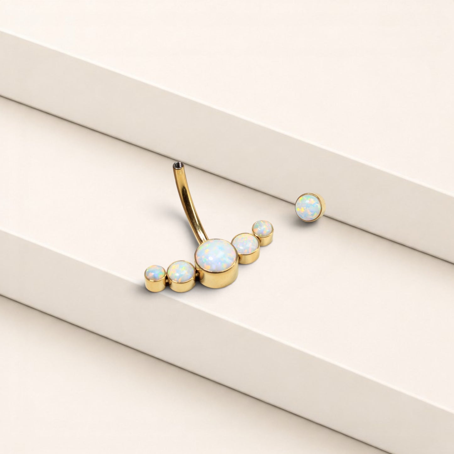 MKBodyJewelry 14G gold titanium floating navel ring featuring a curved barbell with five iridescent opal stones.