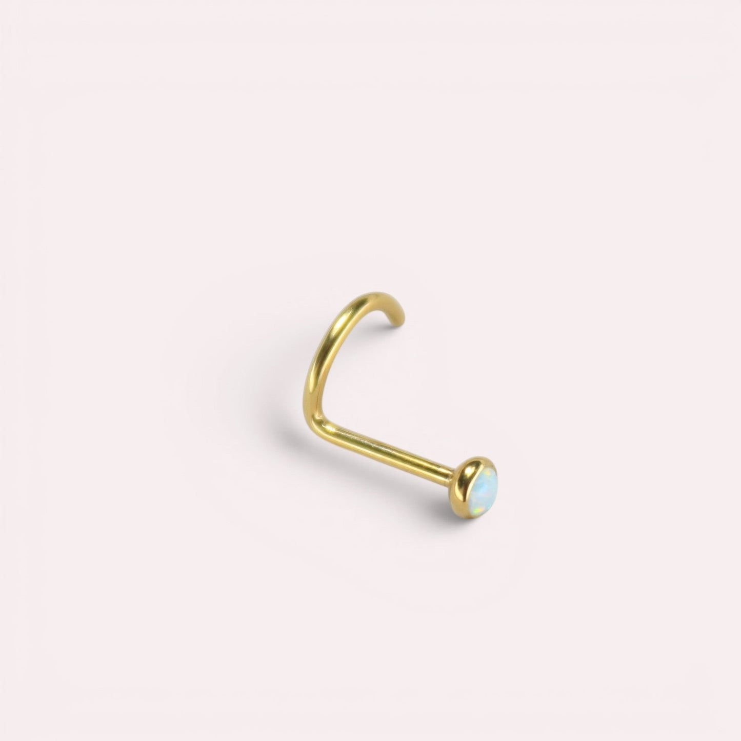 MKBodyJewelry gold titanium nose screw with a 2.5mm round opal gem, featuring a secure corkscrew S-shape design.