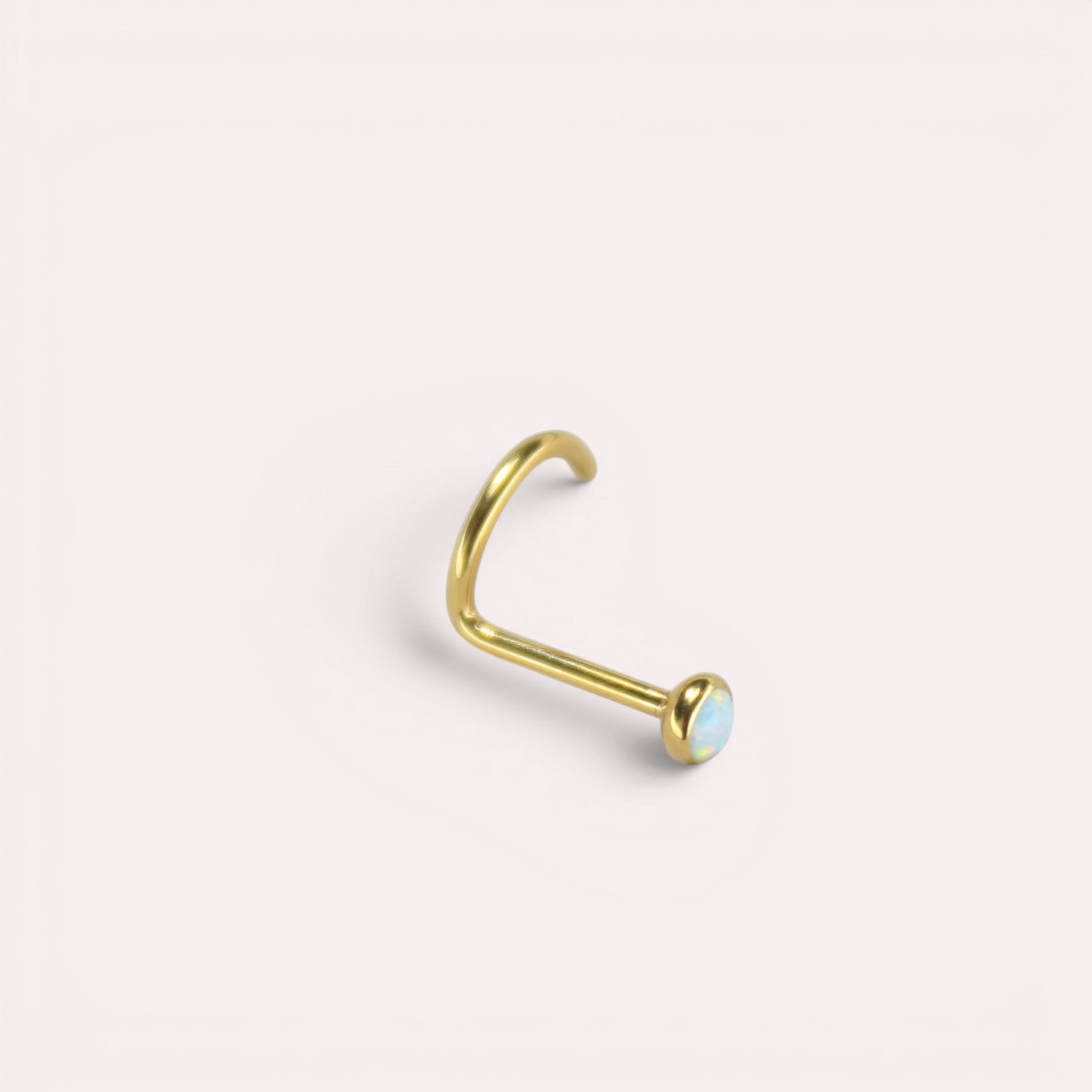 MKBodyJewelry gold titanium nose screw with a 2.5mm round opal gem, featuring a secure corkscrew S-shape design.