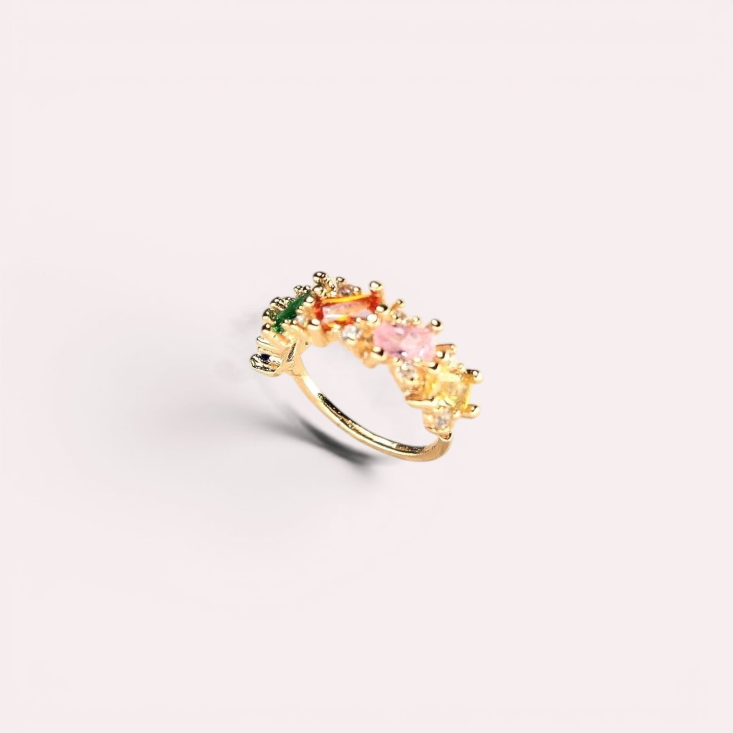 MKBodyJewelry 20g gold nose hoop with a rainbow gradient of baguette cubic zirconia stones on a light background