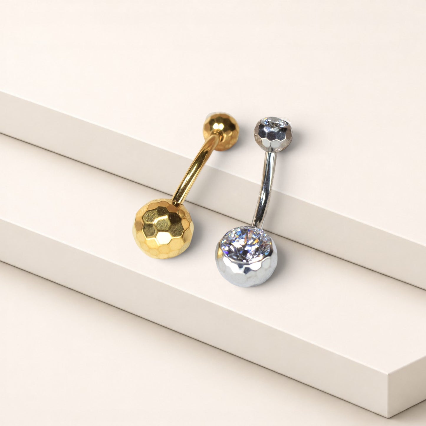 MKBodyJewelry gold and silver titanium belly button rings with faceted honeycomb settings and sparkling CZ stones.