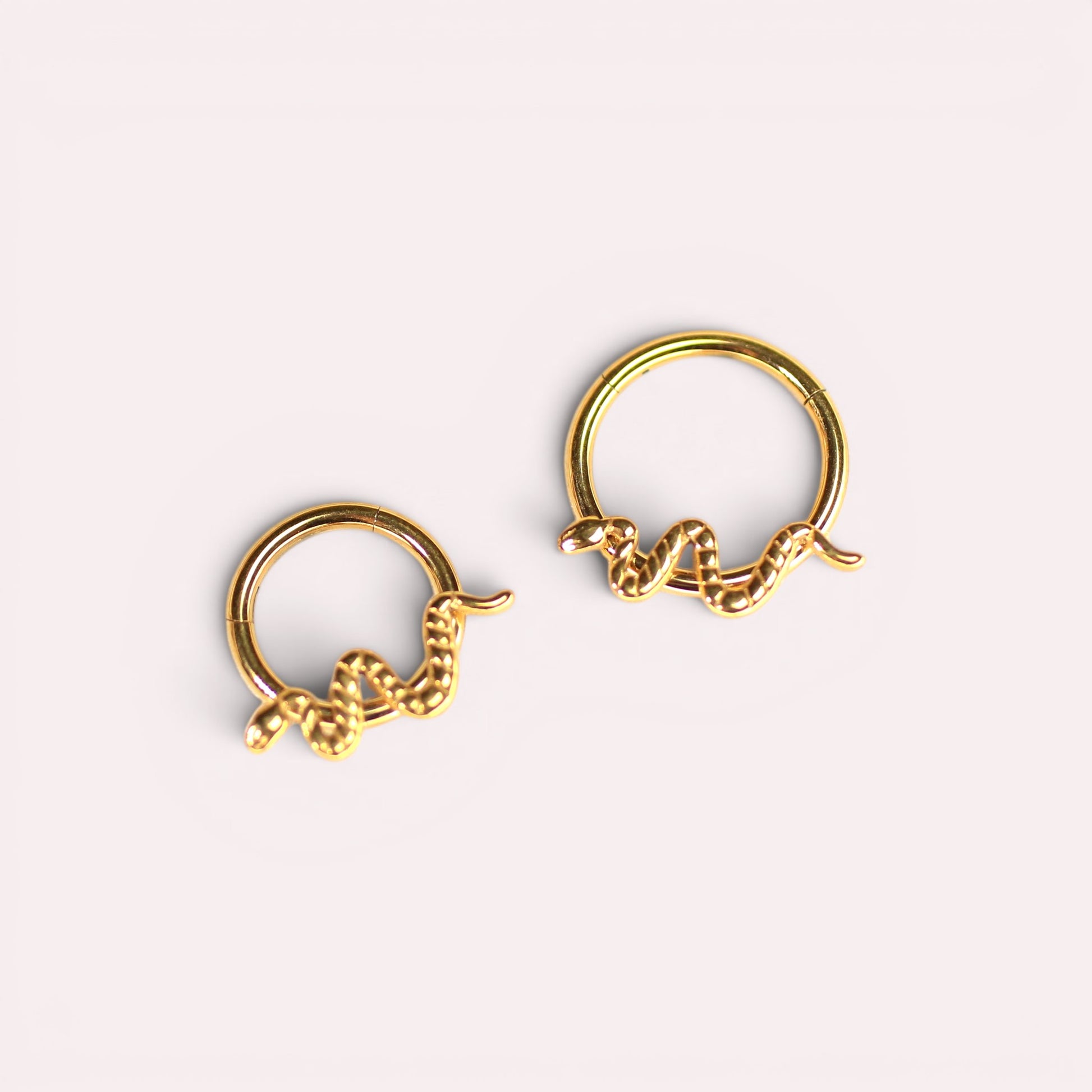 MKBodyJewelry gold snake septum clicker rings made of hypoallergenic titanium in a minimalist hinged hoop design.