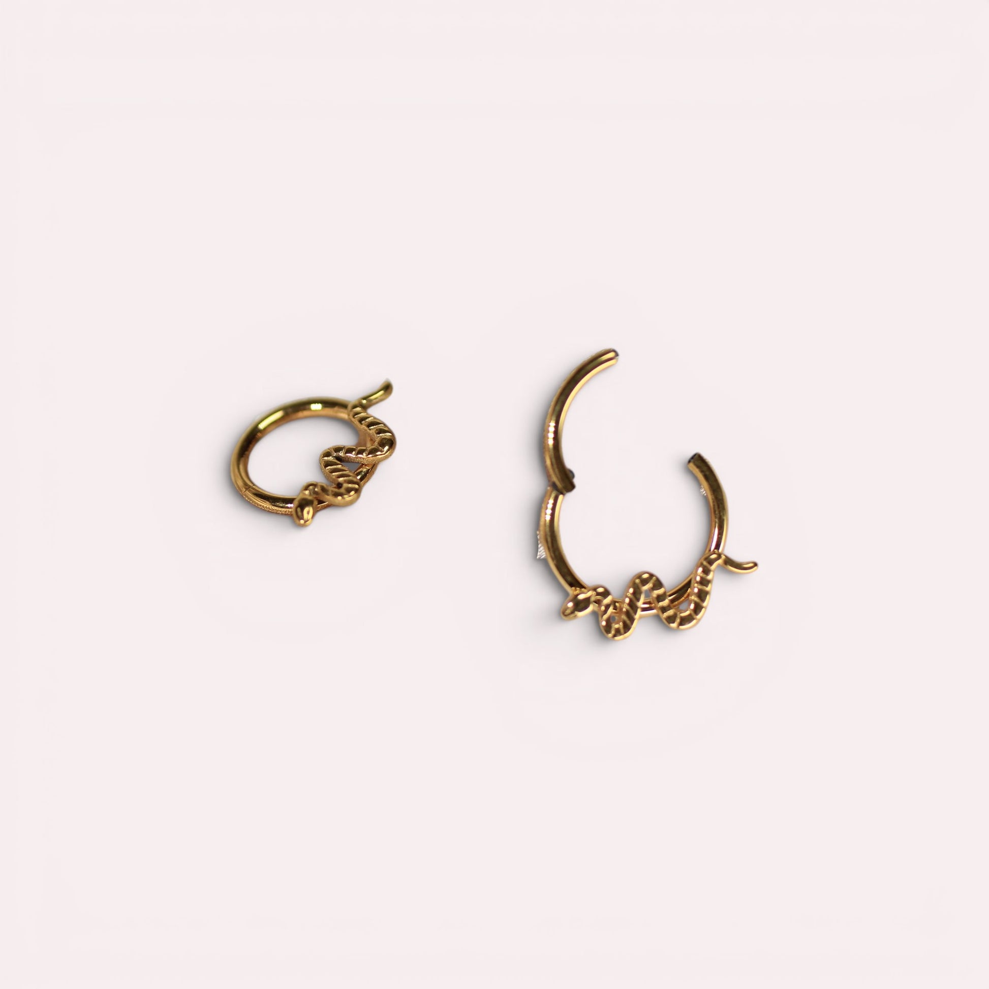 MKBodyJewelry gold snake septum clicker ring made of hypoallergenic titanium in a minimalist hinged hoop design.