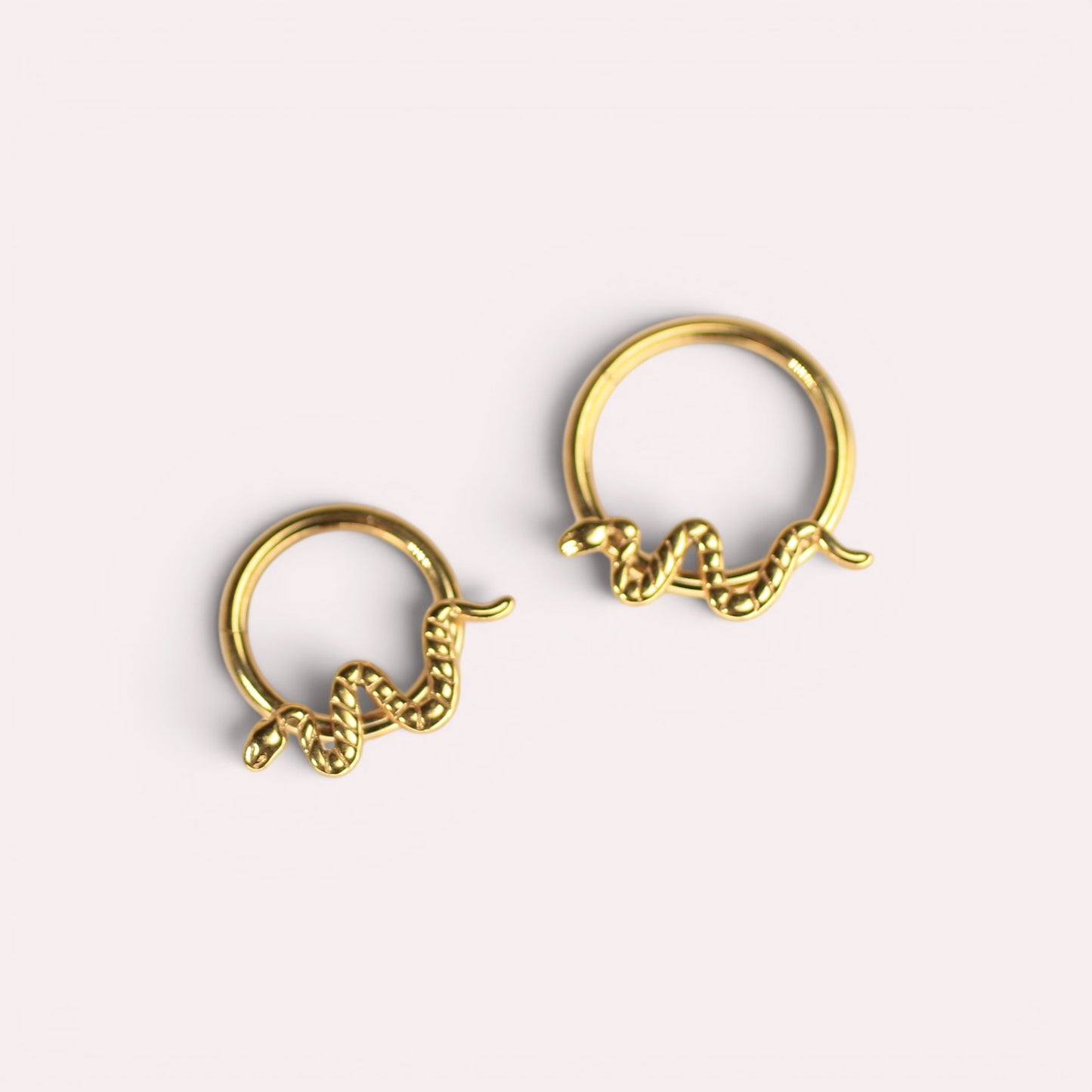 MKBodyJewelry gold snake septum clicker rings made of hypoallergenic titanium for cartilage piercings.