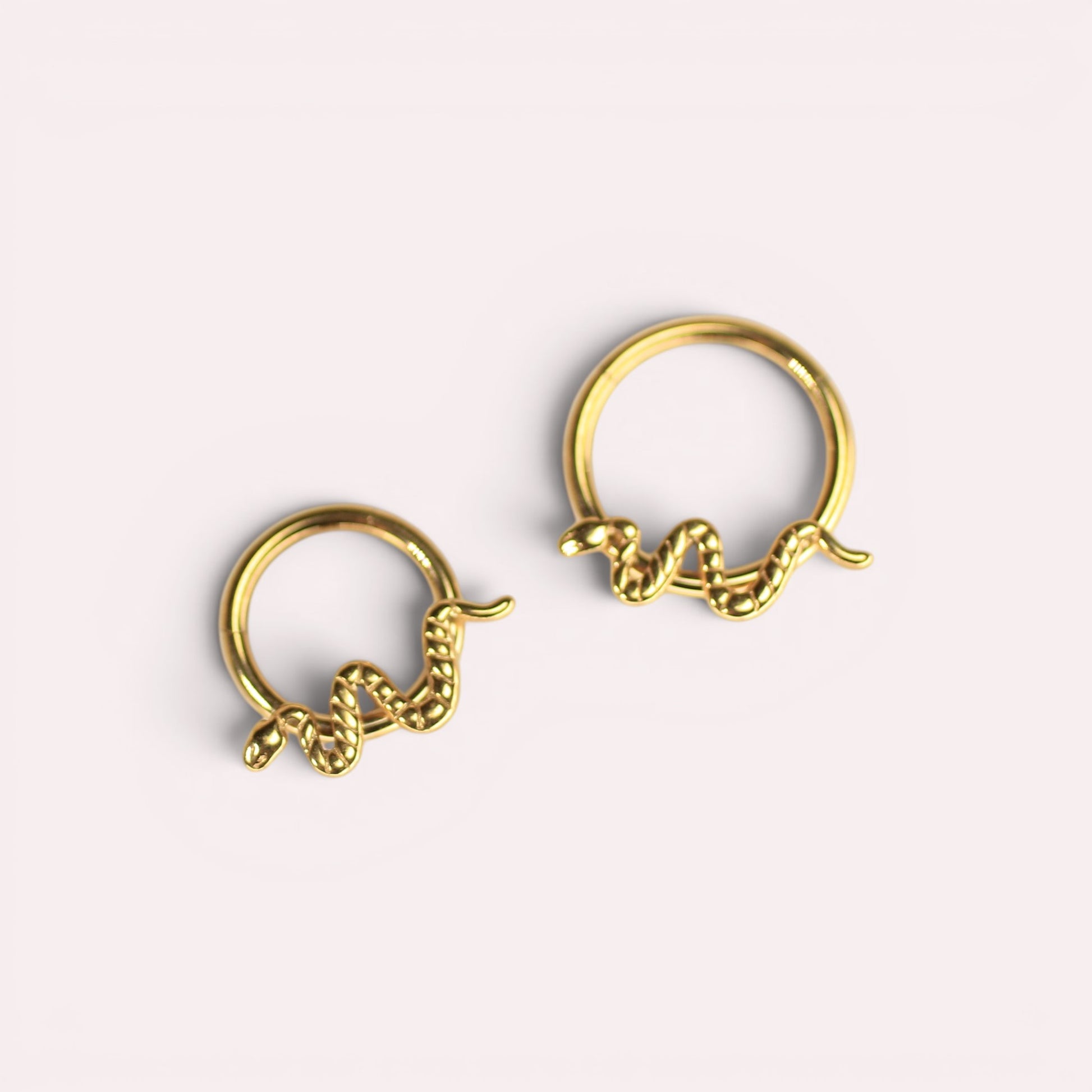 MKBodyJewelry gold snake septum clicker rings made of hypoallergenic titanium for cartilage piercings.
