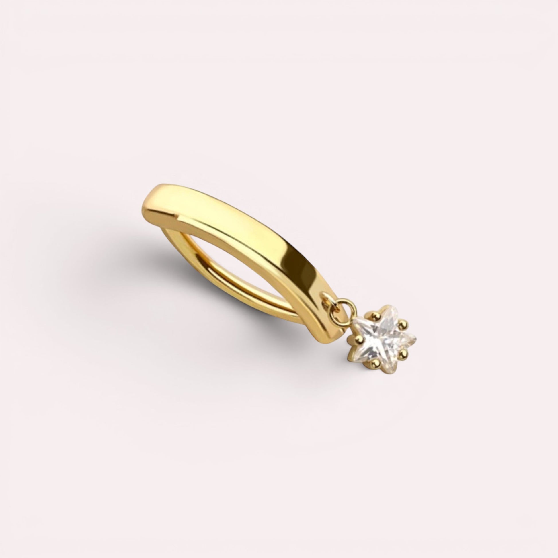 MKBodyJewelry gold surgical steel belly button ring with a dangling star charm and clear crystal accent.