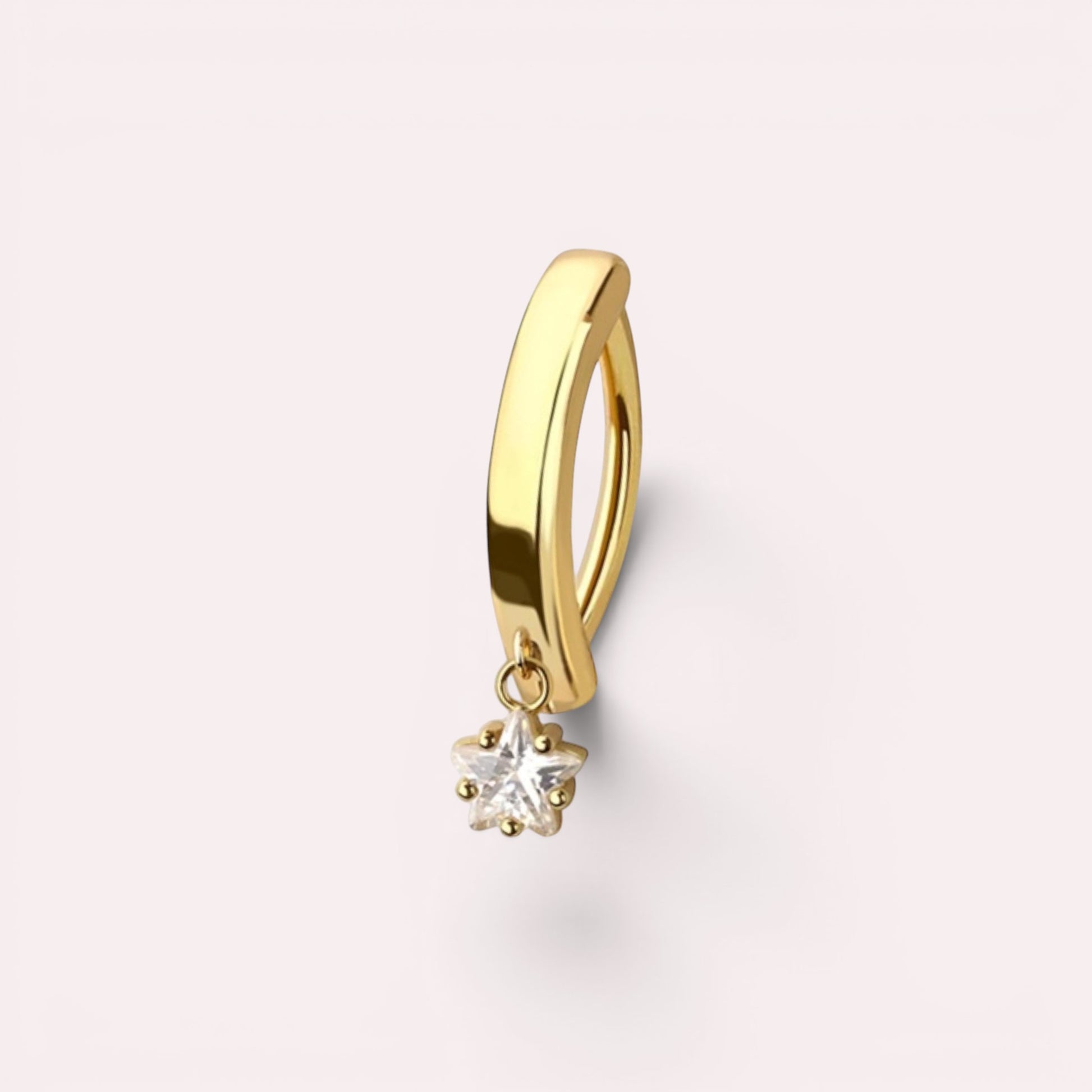 MKBodyJewelry gold surgical steel belly button ring with a minimalist dangling star charm on a light background.