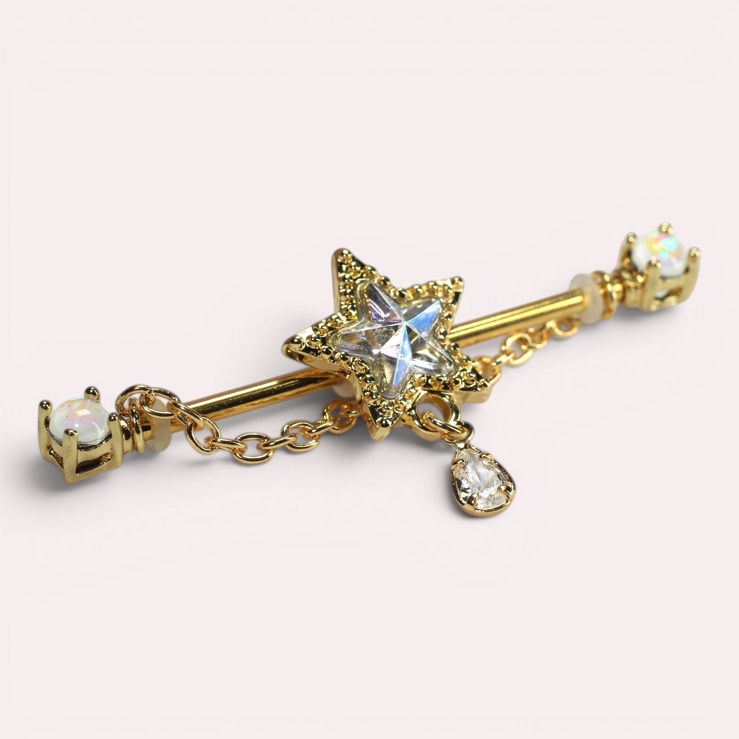 MKBodyJewelry 14G gold industrial barbell with a star charm, dangling chain, and clear gems. Surgical steel.