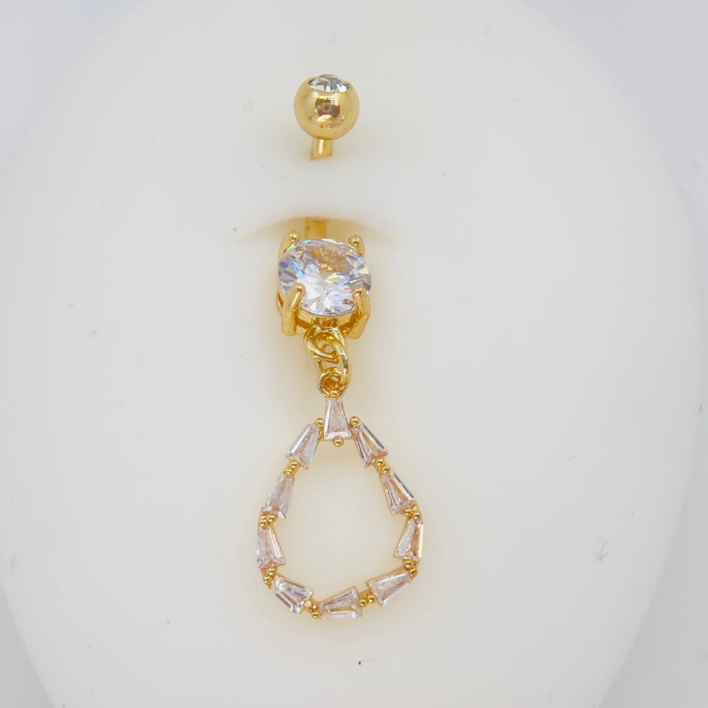 MKBodyJewelry 14G gold surgical steel belly button ring with a dangling teardrop baguette CZ stone charm