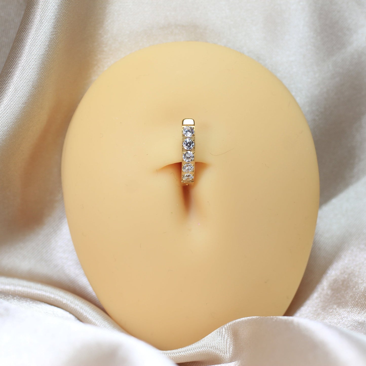 MKBodyJewelry gold titanium belly clicker ring with five clear gems. 14g, 10mm barbell length.