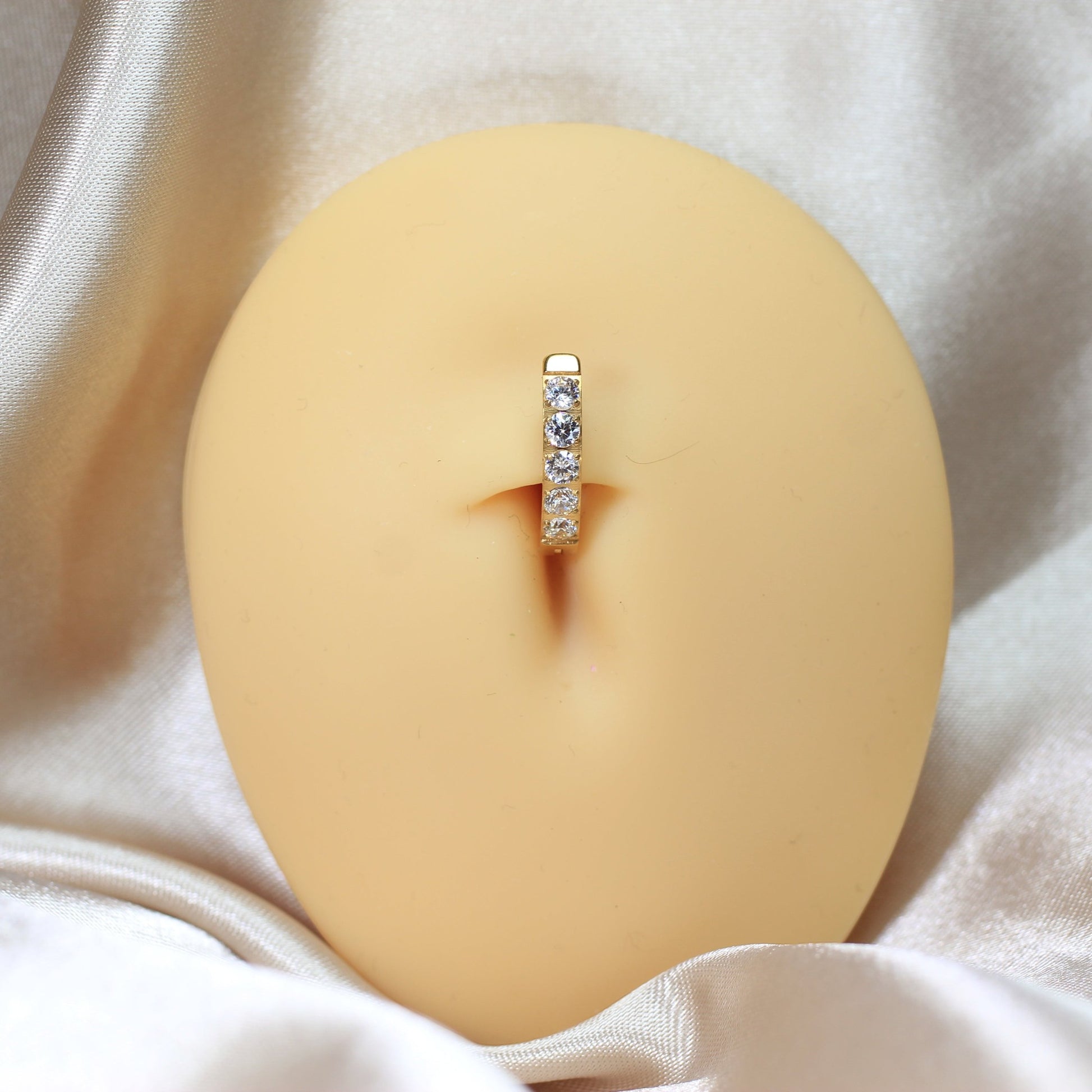 MKBodyJewelry gold titanium belly clicker ring with five clear gems. 14g, 10mm barbell length.