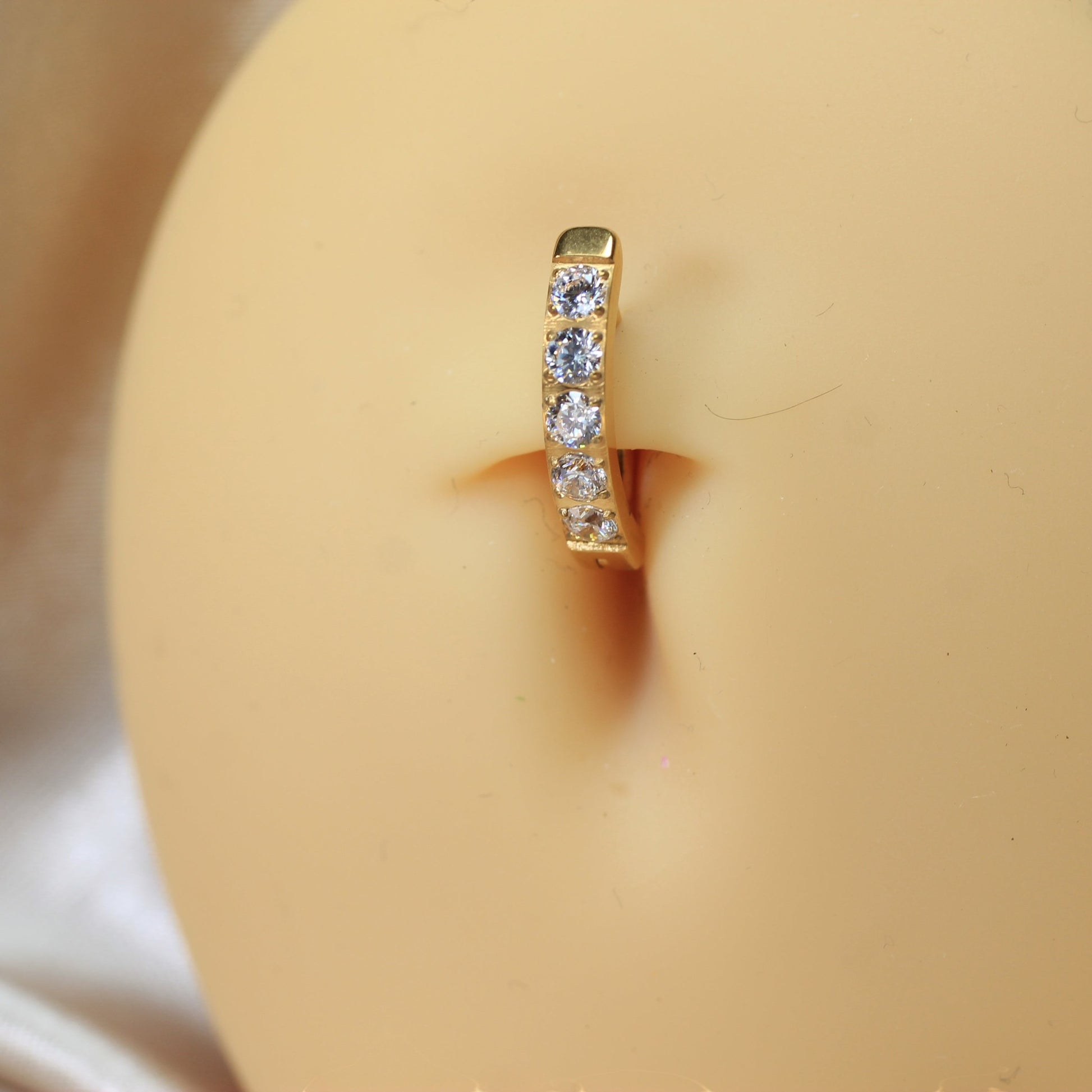 MKBodyJewelry gold titanium belly clicker ring with clear gems. 14g, 10mm barbell length. Minimalist design.
