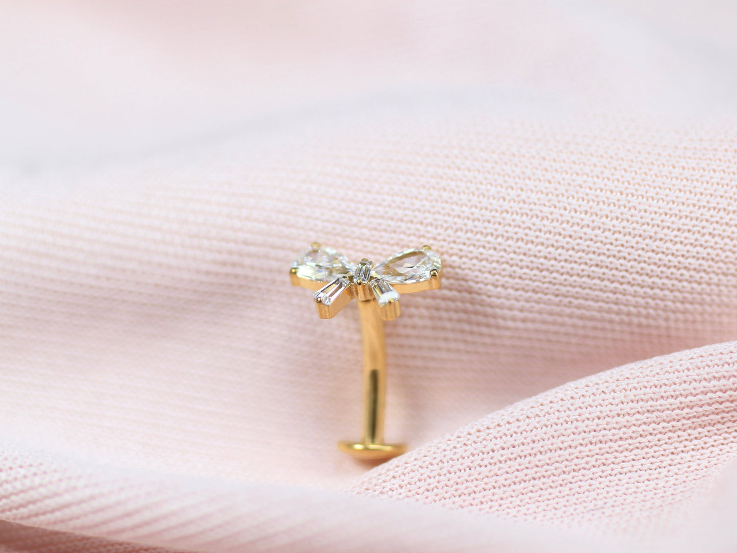 MKBodyJewelry gold titanium threadless bow belly ring with clear crystals. 14G, 10mm barbell.