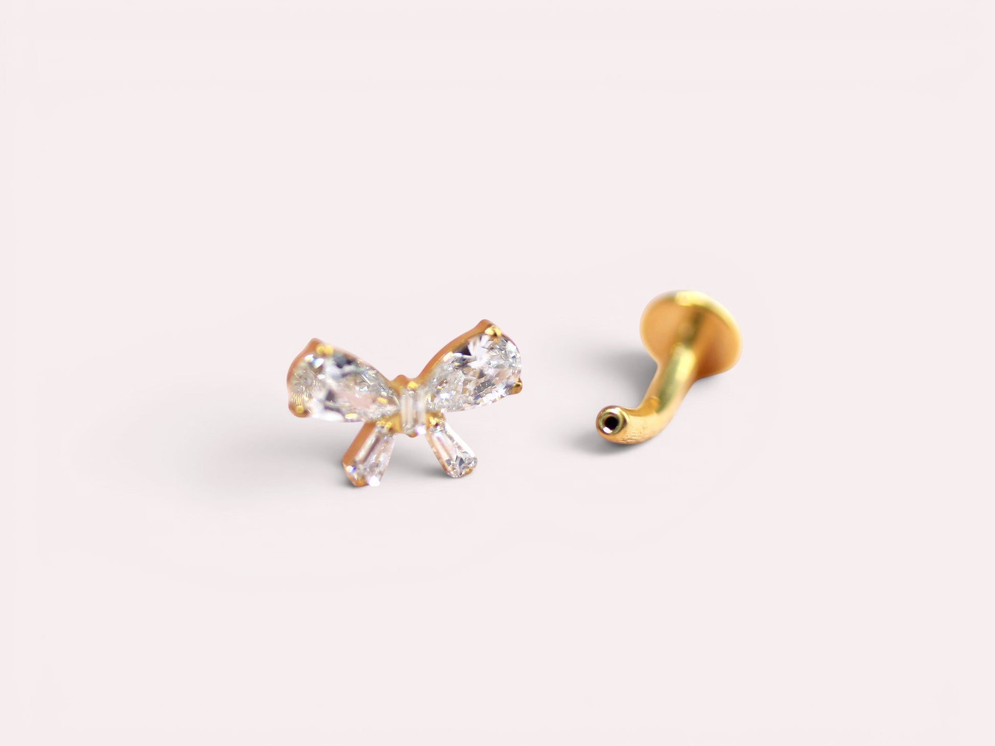 MKBodyJewelry dainty gold titanium threadless bow belly ring with clear cubic zirconia. 14G.