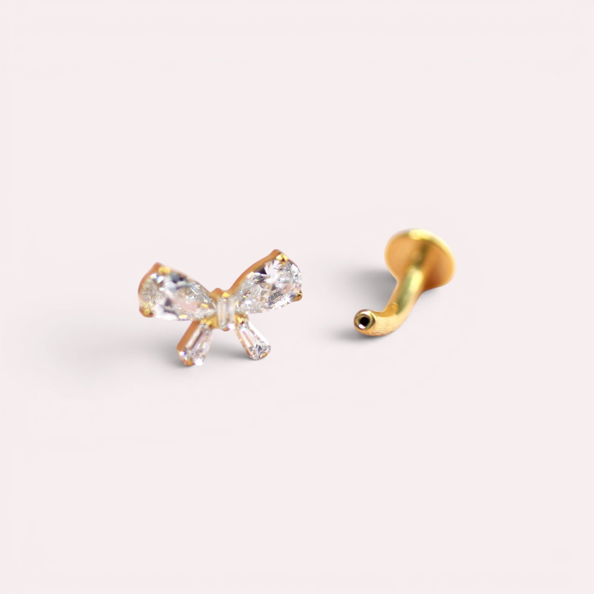 MKBodyJewelry dainty gold titanium threadless bow belly ring with clear cubic zirconia. 14G.